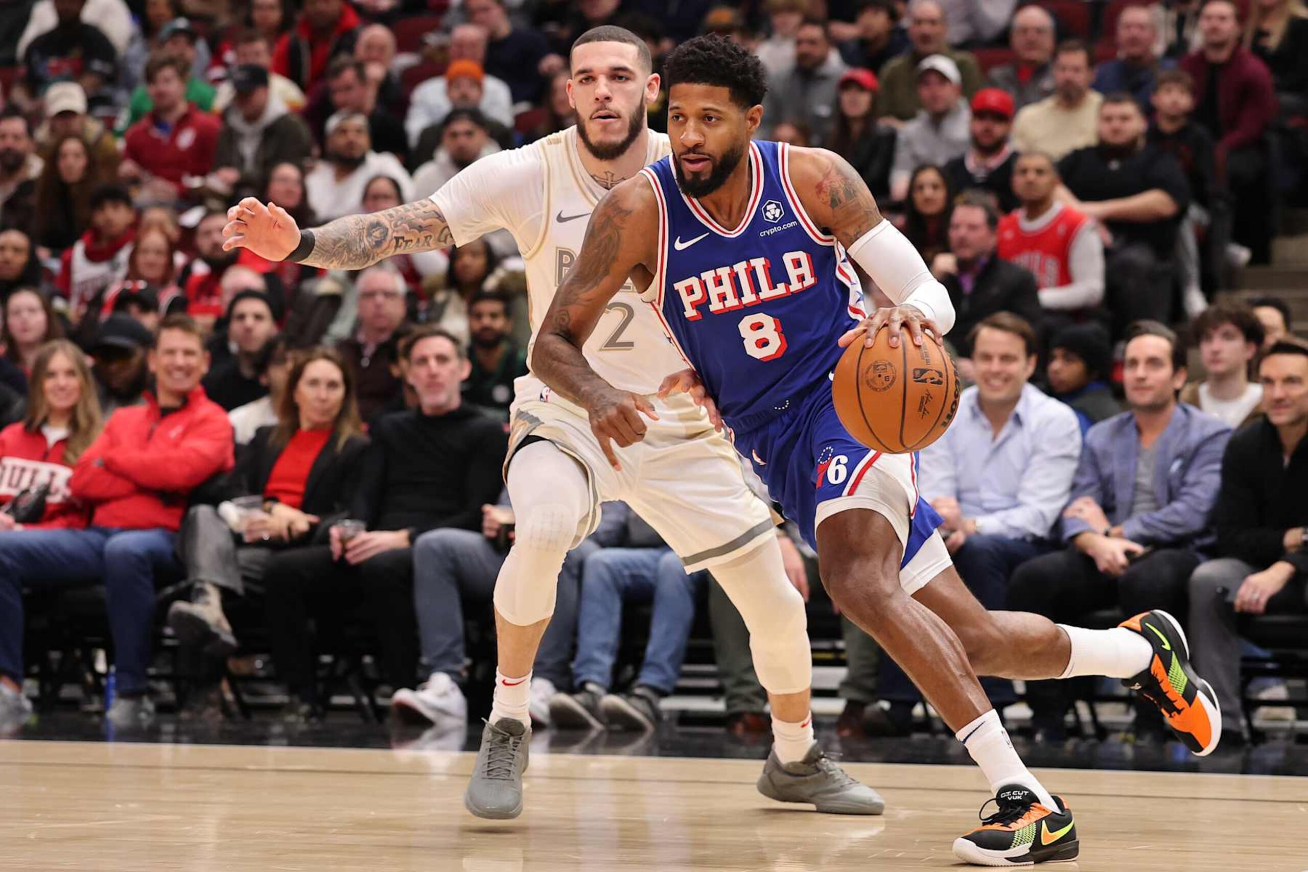 CHICAGO, ILLINOIS - JANUARY 25: Paul George #8 of the Philadelphia 76ers drives to the basket against Lonzo Ball #2 of the Chicago Bulls during the first half at the United Center on January 25, 2025 in Chicago, Illinois. NOTE TO USER: User expressly acknowledges and agrees that, by downloading and or using this photograph, User is consenting to the terms and conditions of the Getty Images License Agreement.  (Photo by Michael Reaves/Getty Images)