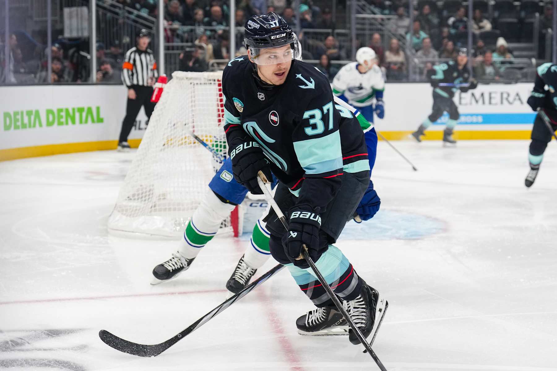 SEATTLE, WASHINGTON - JANUARY 02: Yanni Gourde #37 of the Seattle Kraken pushes the puck during the first period of a game against the Vancouver Canucks at Climate Pledge Arena on January 02, 2025 in Seattle, Washington. (Photo by Christopher Mast/NHLI via Getty Images)
