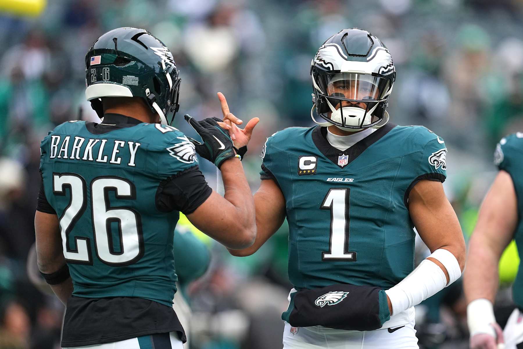 PHILADELPHIA, PENNSYLVANIA - JANUARY 26: Jalen Hurts #1 of the Philadelphia Eagles high fives teammate Saquon Barkley #26 prior to the NFC Championship Game against the Washington Commanders at Lincoln Financial Field on January 26, 2025 in Philadelphia, Pennsylvania.  (Photo by Mitchell Leff/Getty Images)
