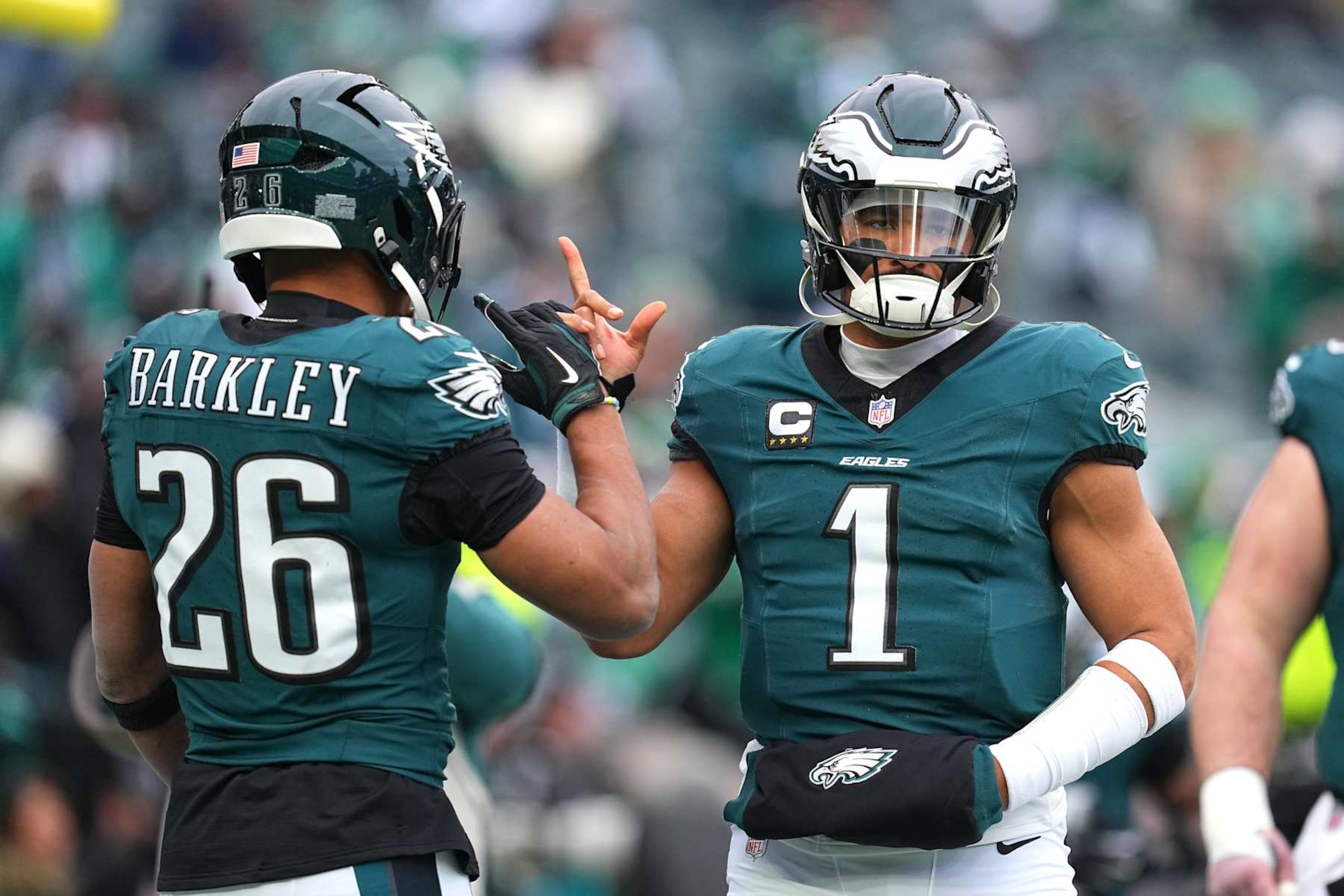 PHILADELPHIA, PENNSYLVANIA - JANUARY 26: Jalen Hurts #1 of the Philadelphia Eagles high fives teammate Saquon Barkley #26 prior to the NFC Championship Game against the Washington Commanders at Lincoln Financial Field on January 26, 2025 in Philadelphia, Pennsylvania.  (Photo by Mitchell Leff/Getty Images)