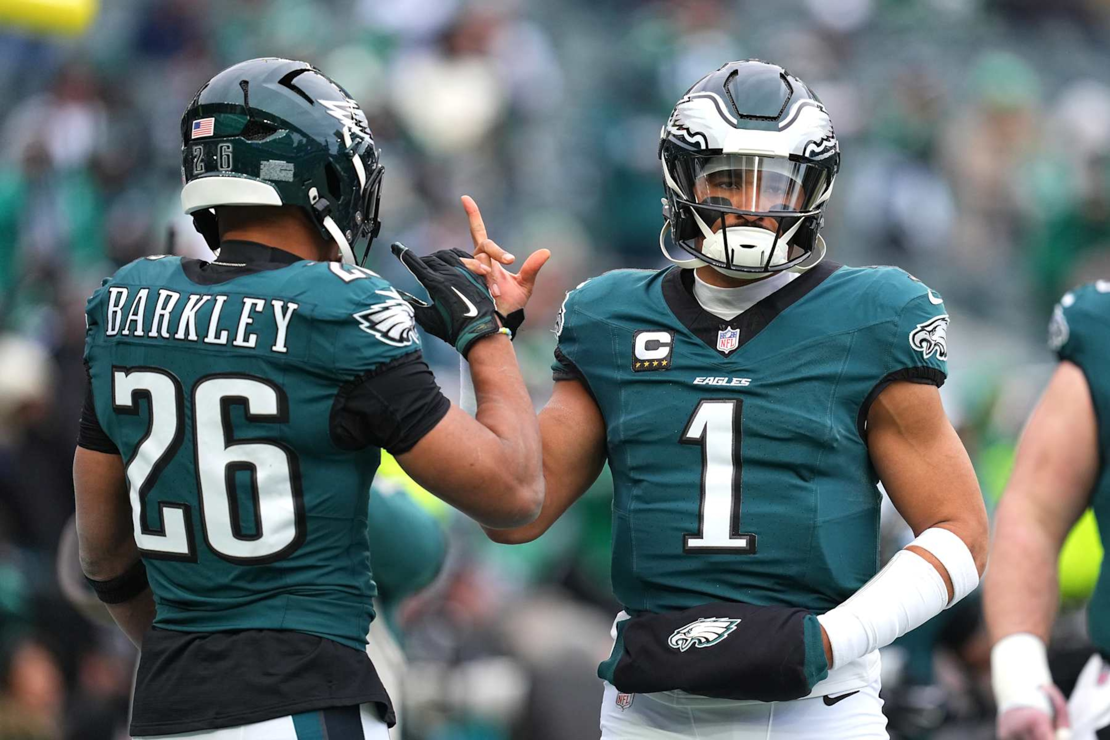 PHILADELPHIA, PENNSYLVANIA - JANUARY 26: Jalen Hurts #1 of the Philadelphia Eagles high fives teammate Saquon Barkley #26 prior to the NFC Championship Game against the Washington Commanders at Lincoln Financial Field on January 26, 2025 in Philadelphia, Pennsylvania.  (Photo by Mitchell Leff/Getty Images)