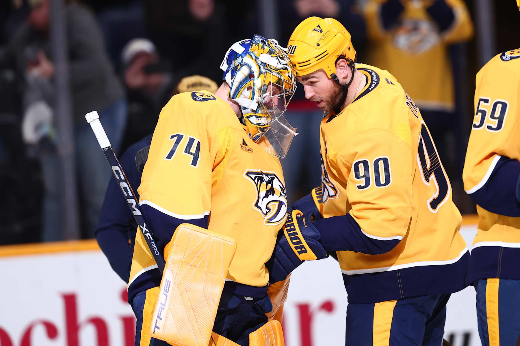 NASHVILLE, TENNESSEE - JANUARY 18:  Juuse Saros #74 of the Nashville Predators celebrates a win over the Minnesota Wild with Ryan O'Reilly #90 on January 18, 2025 at Bridgestone Arena in Nashville. (Photo by Casey Gower/NHLI via Getty Images)