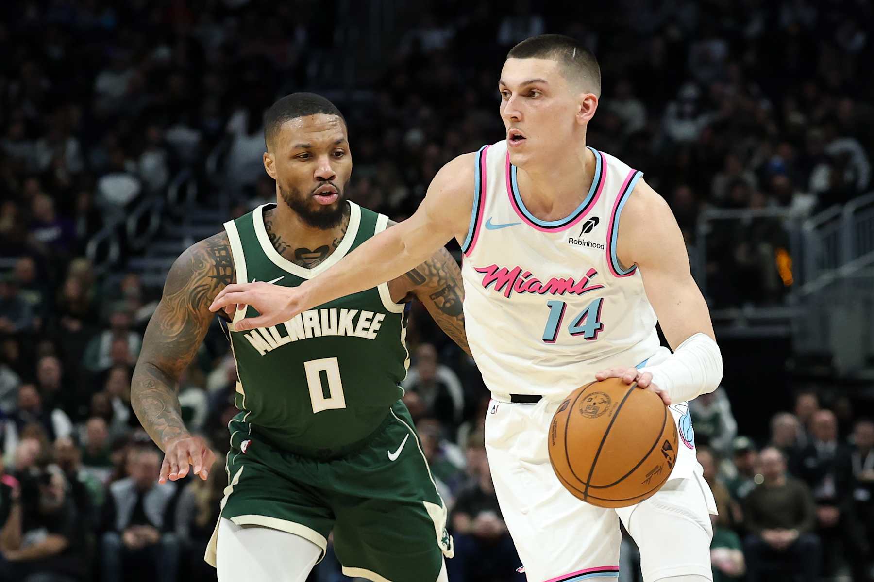 MILWAUKEE, WISCONSIN - JANUARY 23: Tyler Herro #14 of the Miami Heat is defended by Damian Lillard #0 of the Milwaukee Bucks during a game at Fiserv Forum on January 23, 2025 in Milwaukee, Wisconsin.  NOTE TO USER: User expressly acknowledges and agrees that, by downloading and or using this photograph, User is consenting to the terms and conditions of the Getty Images License Agreement. (Photo by Stacy Revere/Getty Images)