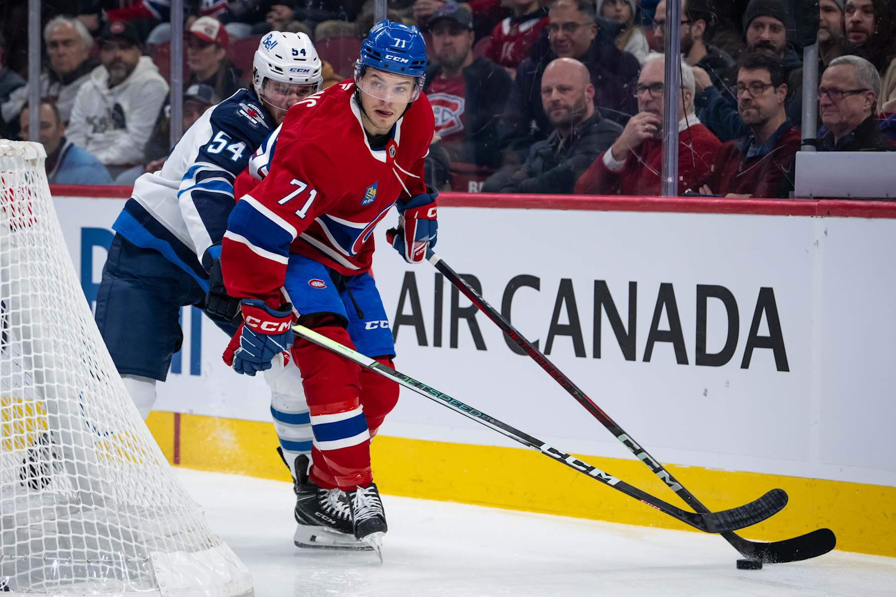 MONTREAL, QC - JANUARY 28: Jake Evans (71) of the Montreal Canadiens skates with the puck away from Dylan Samberg (54) of the Winnipeg Jets during the first period of the NHL game between the Winnipeg Jets and the Montreal Canadiens on Jan 28 2025, at the Bell Centre in Montreal, QC(Photo by Vincent Ethier/Icon Sportswire via Getty Images)