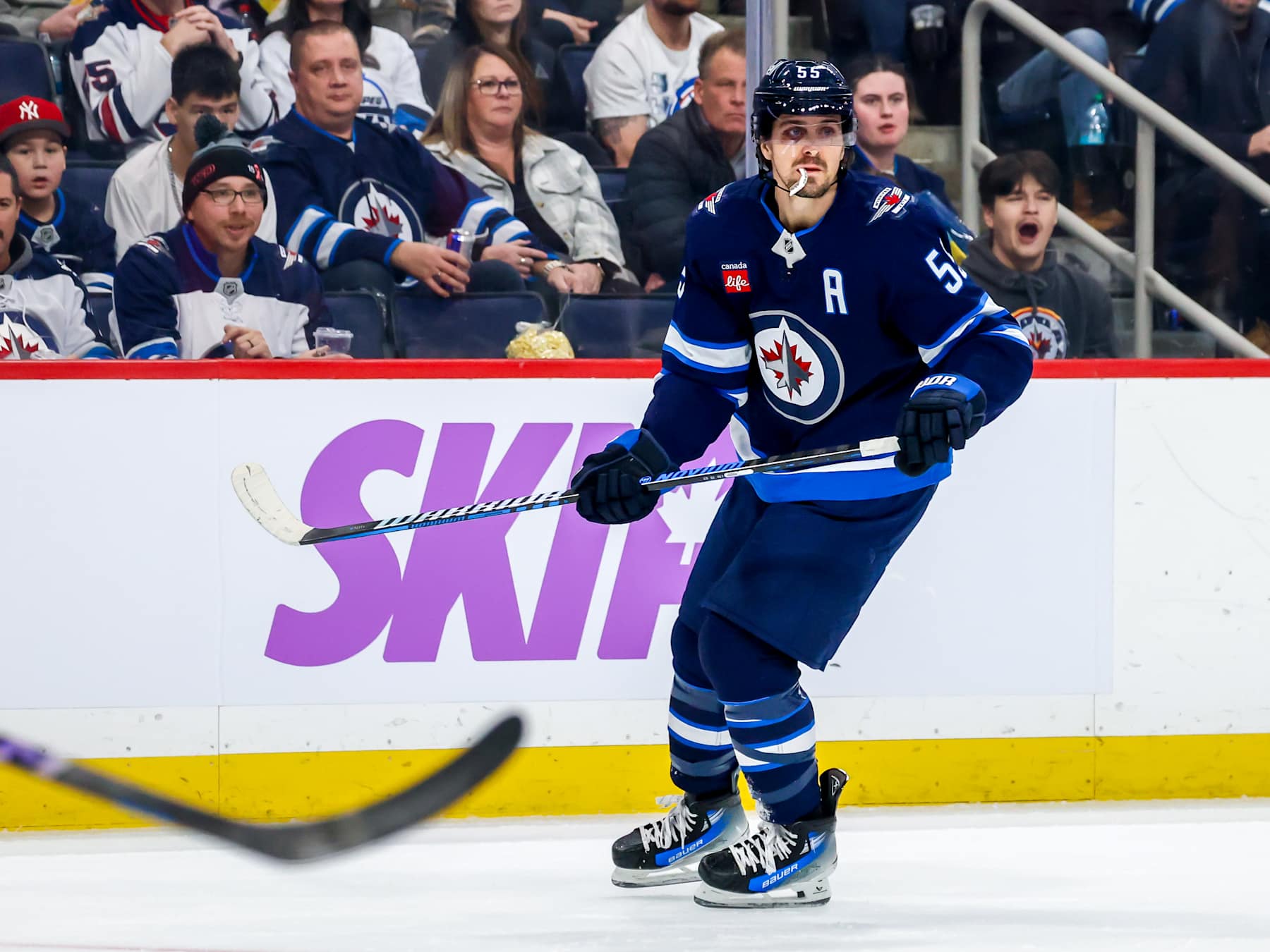 WINNIPEG, CANADA - DECEMBER 03: Mark Scheifele #55 of the Winnipeg Jets skates during second period action against the St. Louis Blues at Canada Life Centre on December 03, 2024 in Winnipeg, Manitoba, Canada. (Photo by Jonathan Kozub/NHLI via Getty Images)