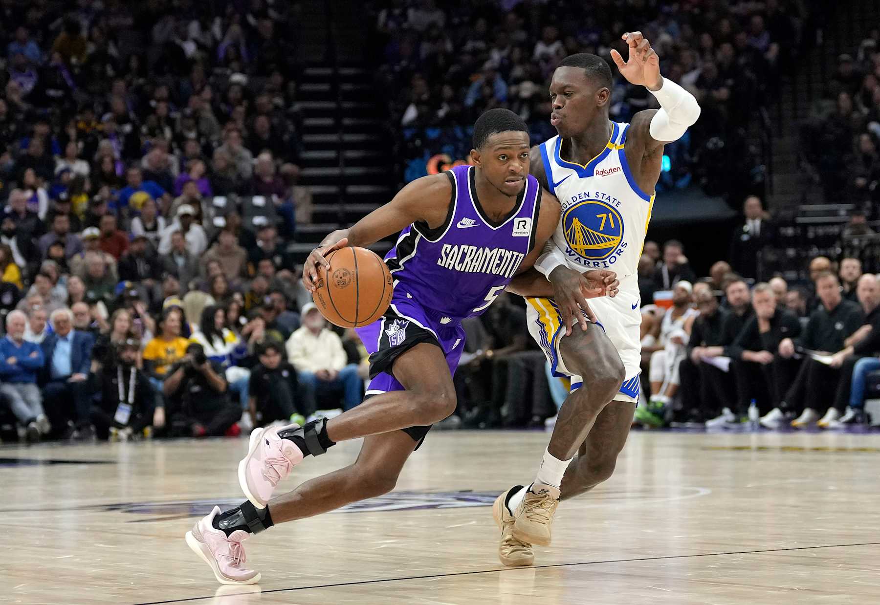 SACRAMENTO, CALIFORNIA - JANUARY 22: De'Aaron Fox #5 of the Sacramento Kings dribbling the ball is guarded by Dennis Schroder #71 of the Golden State Warriors during the second half of an NBA basketball game at Golden 1 Center on January 22, 2025 in Sacramento, California. NOTE TO USER: User expressly acknowledges and agrees that, by downloading and or using this photograph, User is consenting to the terms and conditions of the Getty Images License Agreement. (Photo by Thearon W. Henderson/Getty Images)