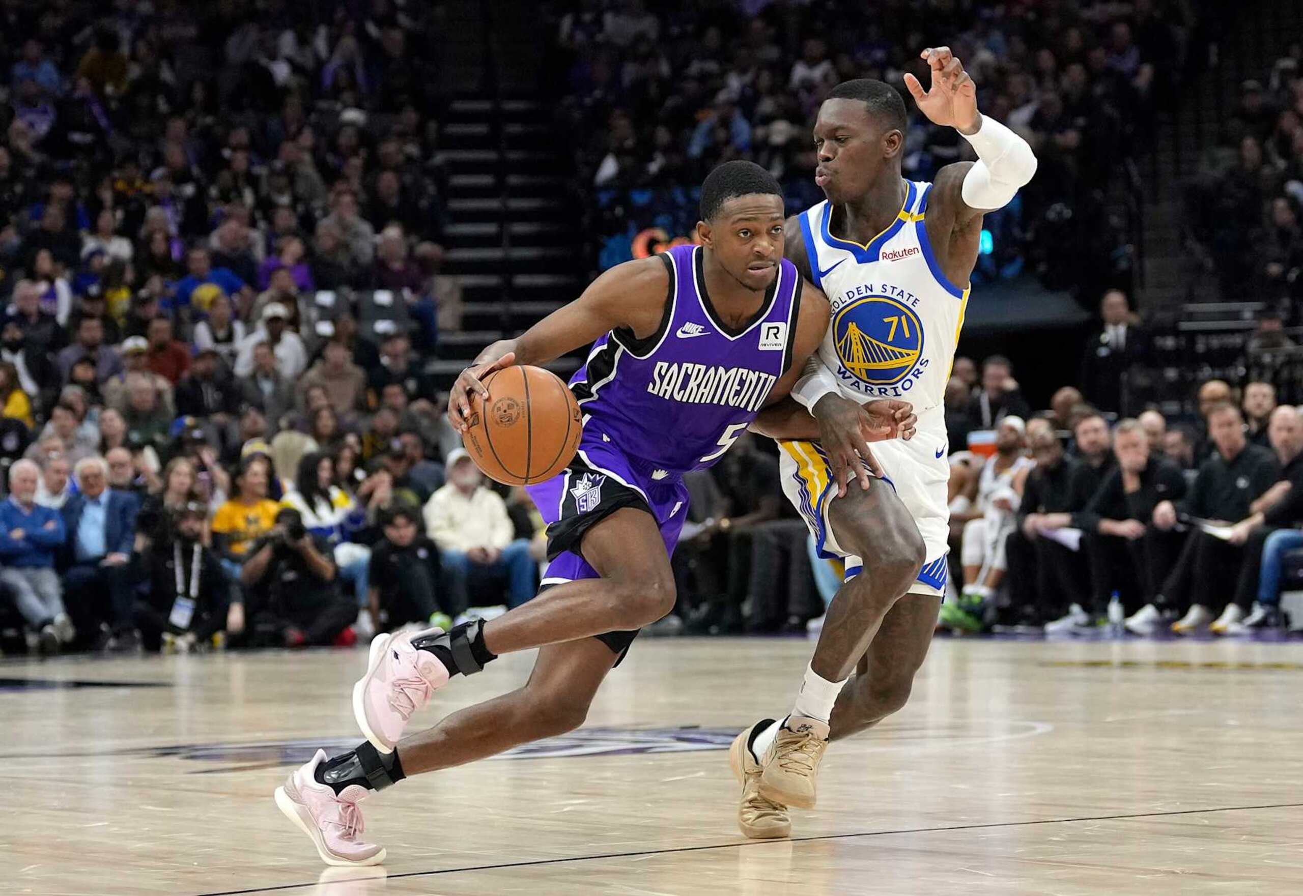 SACRAMENTO, CALIFORNIA - JANUARY 22: De'Aaron Fox #5 of the Sacramento Kings dribbling the ball is guarded by Dennis Schroder #71 of the Golden State Warriors during the second half of an NBA basketball game at Golden 1 Center on January 22, 2025 in Sacramento, California. NOTE TO USER: User expressly acknowledges and agrees that, by downloading and or using this photograph, User is consenting to the terms and conditions of the Getty Images License Agreement. (Photo by Thearon W. Henderson/Getty Images) SACRAMENTO, CALIFORNIA - JANUARY 22: De'Aaron Fox #5 of the Sacramento Kings dribbling the ball is guarded by Dennis Schroder #71 of the Golden State Warriors during the second half of an NBA basketball game at Golden 1 Center on January 22, 2025 in Sacramento, California. NOTE TO USER: User expressly acknowledges and agrees that, by downloading and or using this photograph, User is consenting to the terms and conditions of the Getty Images License Agreement. (Photo by Thearon W. Henderson/Getty Images)