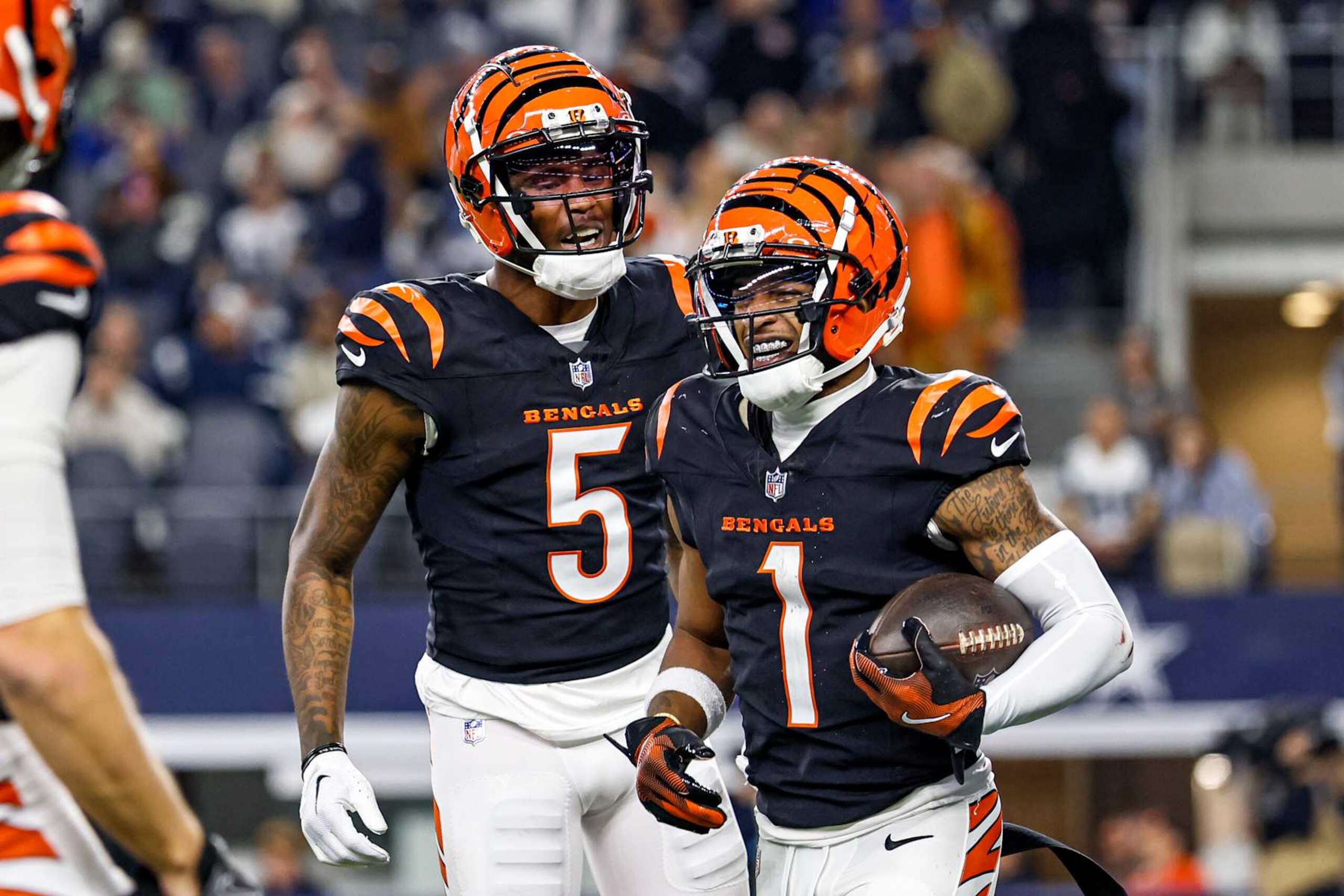 ARLINGTON, TX - DECEMBER 09: Cincinnati Bengals wide receiver Ja'Marr Chase (1) celebrates with wide receiver Tee Higgins (5) after a touchdown during the game between the Dallas Cowboys and the Cincinnati Bengals on December 9, 2024 at AT&T Stadium in Arlington, Texas. (Photo by Matthew Pearce/Icon Sportswire via Getty Images) ARLINGTON, TX - DECEMBER 09: Cincinnati Bengals wide receiver Ja'Marr Chase (1) celebrates with wide receiver Tee Higgins (5) after a touchdown during the game between the Dallas Cowboys and the Cincinnati Bengals on December 9, 2024 at AT&T Stadium in Arlington, Texas. (Photo by Matthew Pearce/Icon Sportswire via Getty Images)