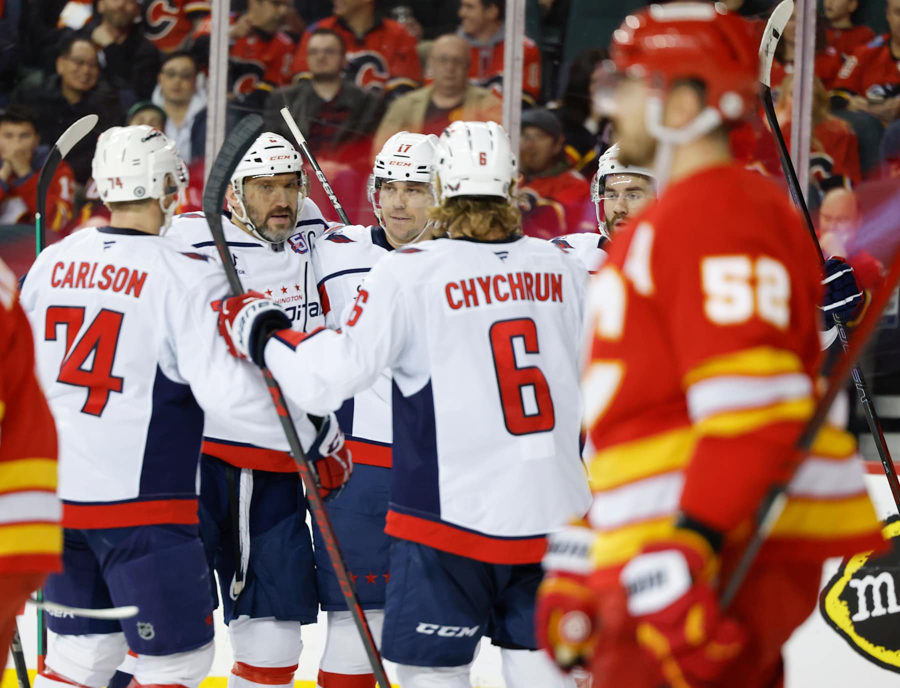 CALGARY, CANADA - JANUARY 28:  Dylan Strome #17 of the Washington Capitals celebrates his second-period goal against the Calgary Flames with teammates at the Scotiabank Saddledome on January 28, 2025, in Calgary, Alberta, Canada. (Photo by Leah Hennel/Getty Images)