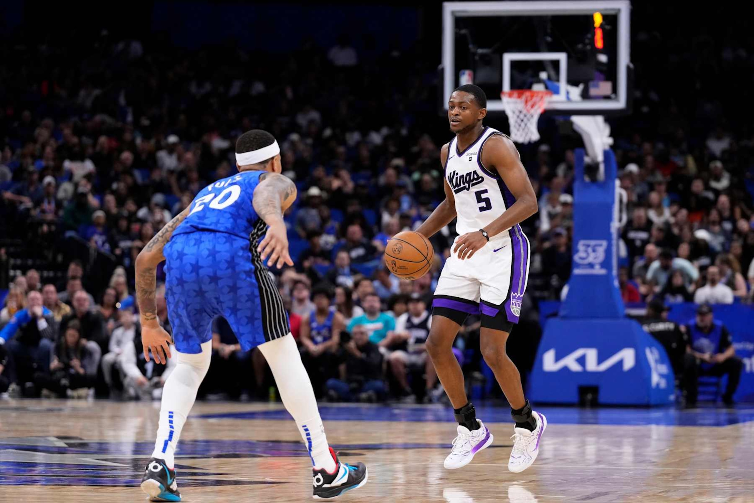ORLANDO, FLORIDA - MARCH 23: De'Aaron Fox #5 of the Sacramento Kings dribbles the ball against Markelle Fultz #20 of the Orlando Magic during the second quarter at Kia Center on March 23, 2024 in Orlando, Florida. NOTE TO USER: User expressly acknowledges and agrees that, by downloading and or using this photograph, User is consenting to the terms and conditions of the Getty Images License Agreement. (Photo by Rich Storry/Getty Images)
