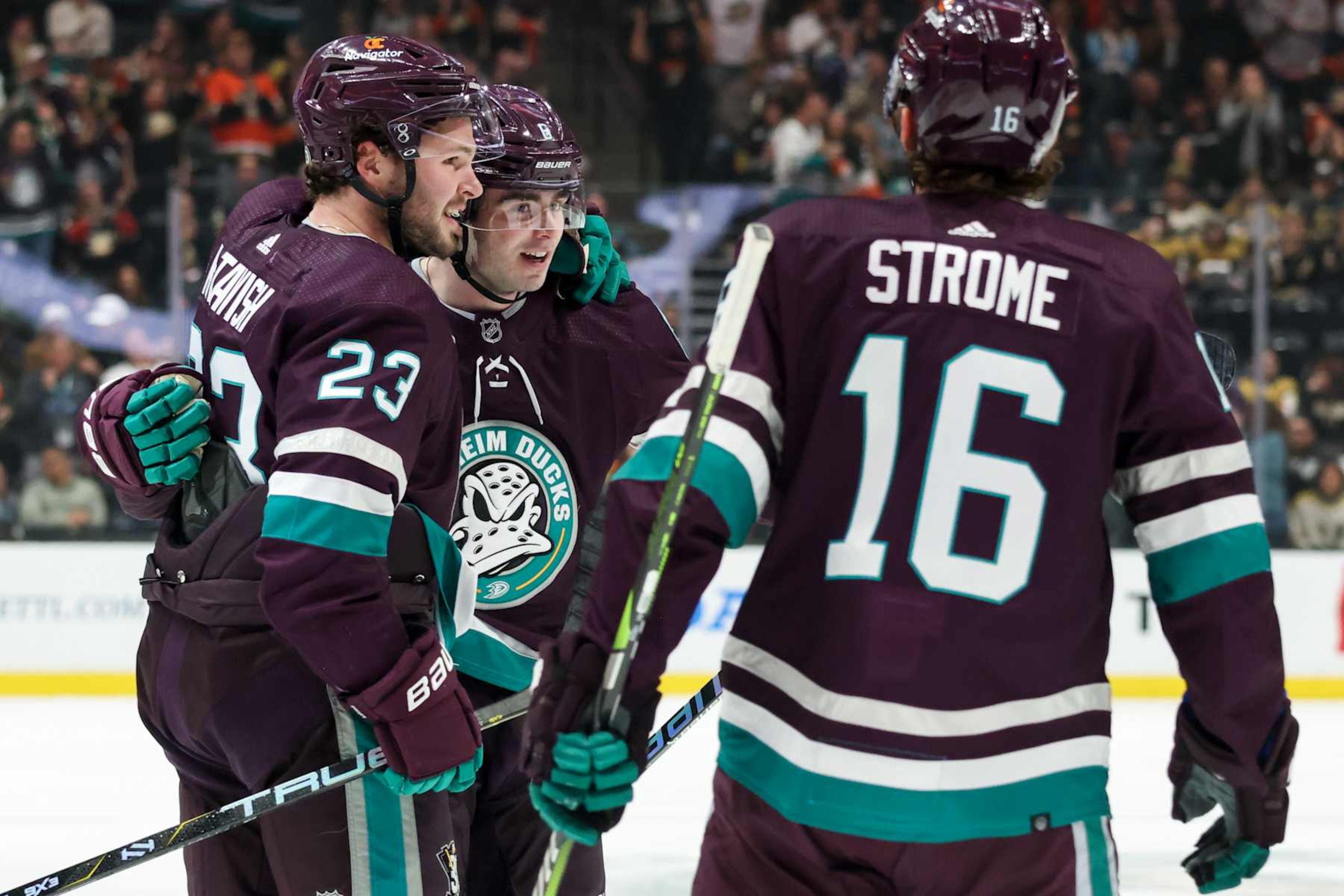 ANAHEIM, CA  DECEMBER 27:  Mason McTavish #23, Jamie Drysdale #6, and Ryan Strome #16 of the Anaheim Ducks celebrate a first period goal during the game against the Vegas Golden Knights on December 27, 2023 at Honda Center in Anaheim, California. (Photo by Debora Robinson NHLI via Getty Images)