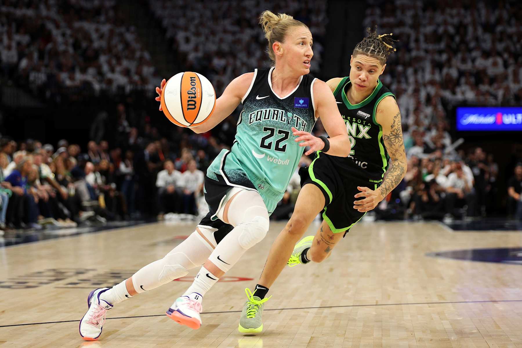 MINNEAPOLIS, MINNESOTA - OCTOBER 18: Courtney Vandersloot #22 of the New York Liberty drives to the basket past Natisha Hiedeman #2 of the Minnesota Lynx in the third quarter of Game Four of the WNBA Finals at Target Center on October 18, 2024 in Minneapolis, Minnesota. The Lynx defeated the Liberty 82-80. NOTE TO USER: User expressly acknowledges and agrees that, by downloading and or using this photograph, User is consenting to the terms and conditions of the Getty Images License Agreement. (Photo by David Berding/Getty Images)