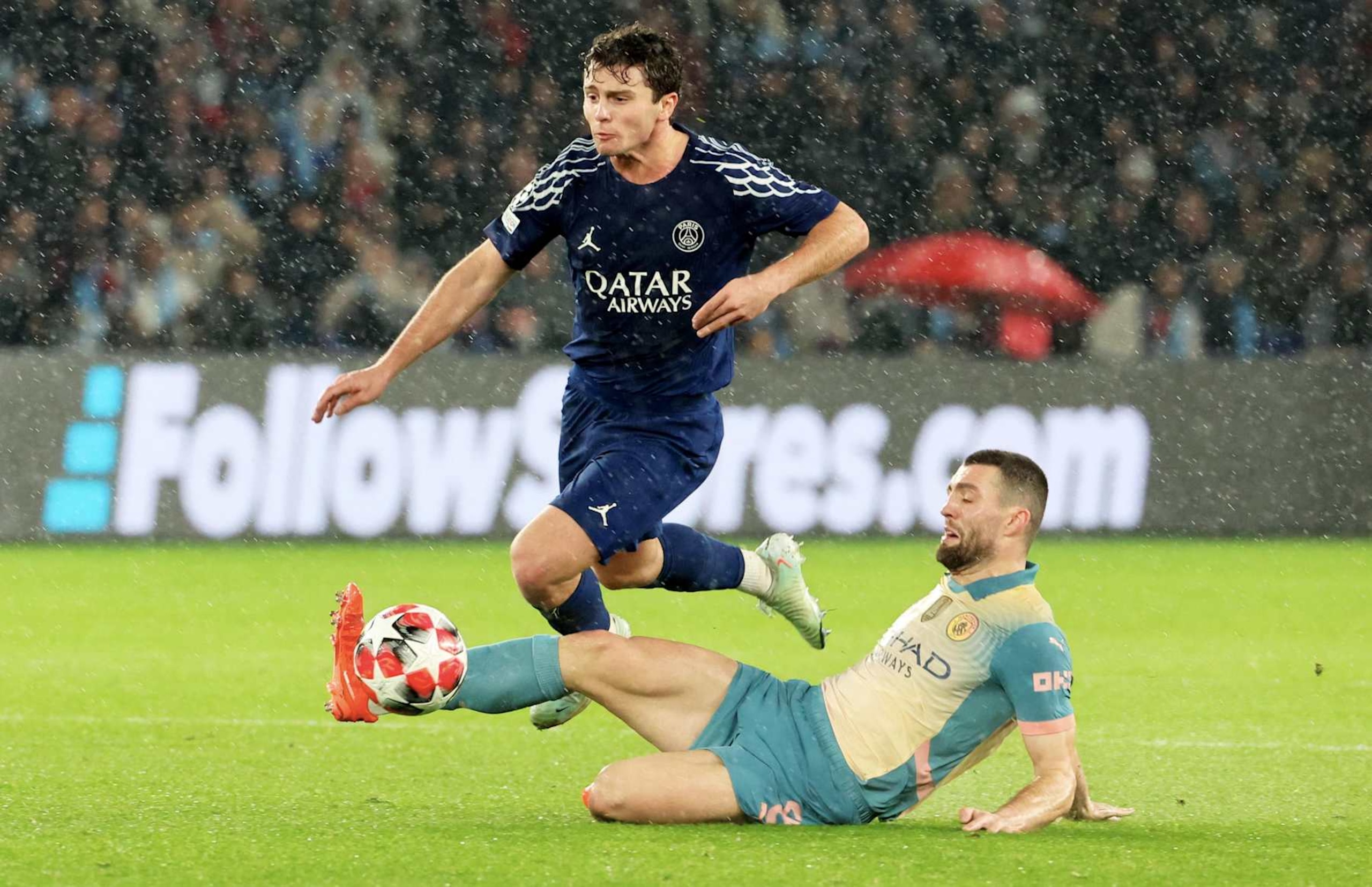 PARIS, FRANCE - JANUARY 22: Joao Neves #87 of Paris Saint-Germain is tackle by Mateo Kovacic #8 of Manchester City during the UEFA Champions League 2024/25 League Phase MD7 match between Paris Saint-Germain and Manchester City  at Parc des Princes on January 22, 2025 in Paris, France. (Photo by Xavier Laine/Getty Images)