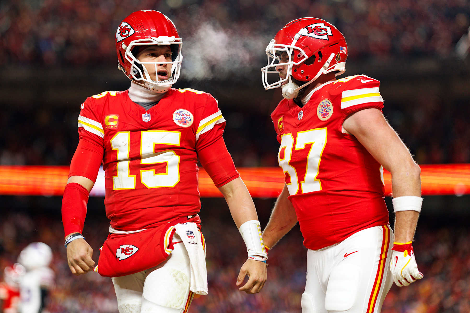 KANSAS CITY, MISSOURI - JANUARY 26: Quarterback Patrick Mahomes #15 of the Kansas City Chiefs celebrates with tight end Travis Kelce #87 after a touchdown during the second half of the AFC Championship football game against the Buffalo Bills, at GEHA Field at Arrowhead Stadium on January 26, 2025 in Kansas City, Missouri. (Photo by Brooke Sutton/Getty Images)