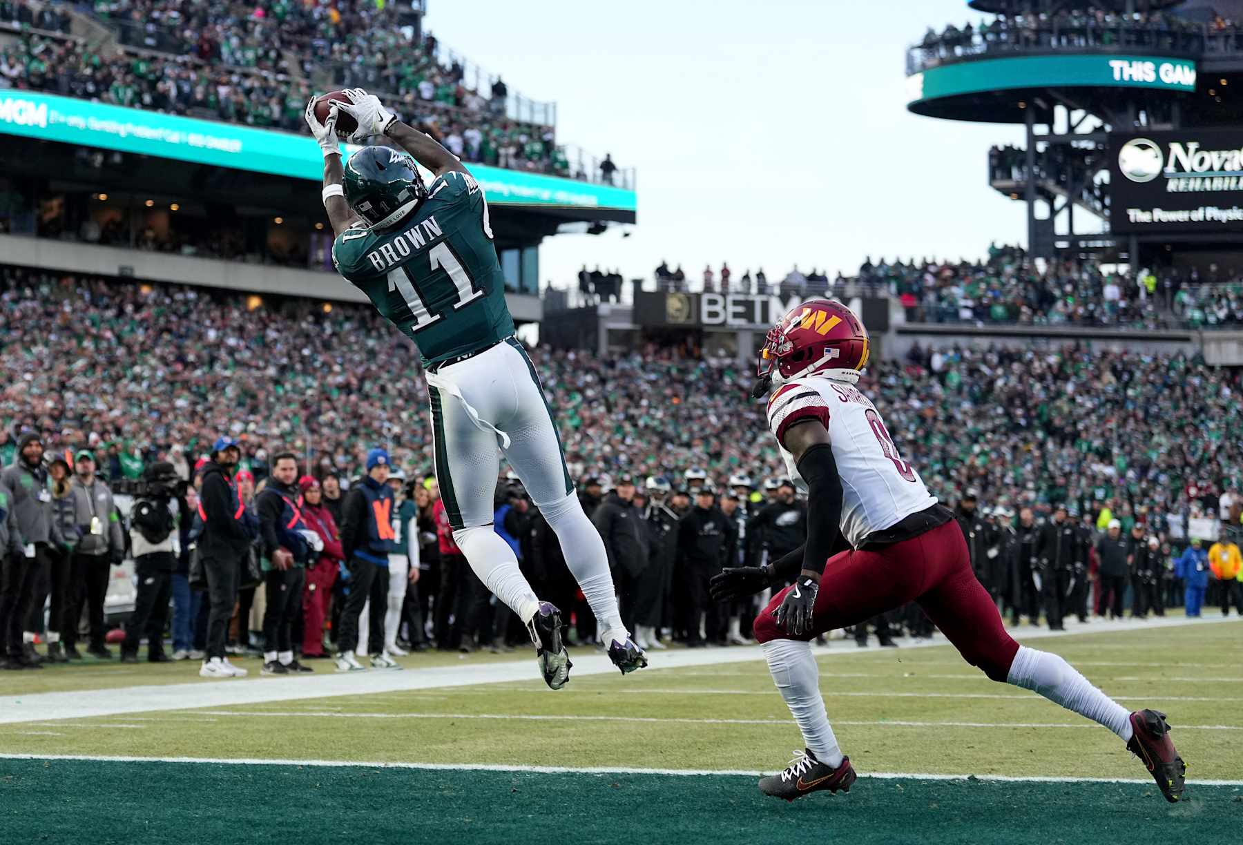PHILADELPHIA, PENNSYLVANIA - JANUARY 26: A.J. Brown #11 of the Philadelphia Eagles catches a touchdown against Mike Sainristil #0 of the Washington Commanders during the second quarter in the NFC Championship Game at Lincoln Financial Field on January 26, 2025 in Philadelphia, Pennsylvania.  (Photo by Mitchell Leff/Getty Images)