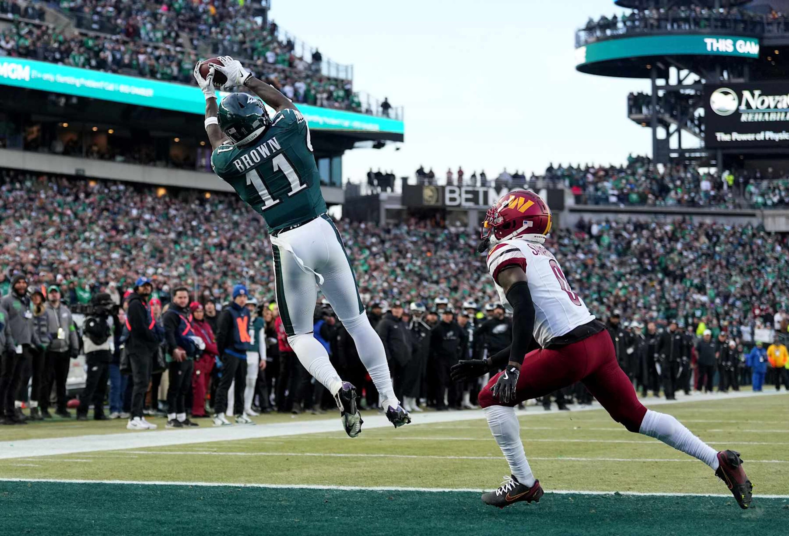 PHILADELPHIA, PENNSYLVANIA - JANUARY 26: A.J. Brown #11 of the Philadelphia Eagles catches a touchdown against Mike Sainristil #0 of the Washington Commanders during the second quarter in the NFC Championship Game at Lincoln Financial Field on January 26, 2025 in Philadelphia, Pennsylvania. (Photo by Mitchell Leff/Getty Images) PHILADELPHIA, PENNSYLVANIA - JANUARY 26: A.J. Brown #11 of the Philadelphia Eagles catches a touchdown against Mike Sainristil #0 of the Washington Commanders during the second quarter in the NFC Championship Game at Lincoln Financial Field on January 26, 2025 in Philadelphia, Pennsylvania. (Photo by Mitchell Leff/Getty Images)