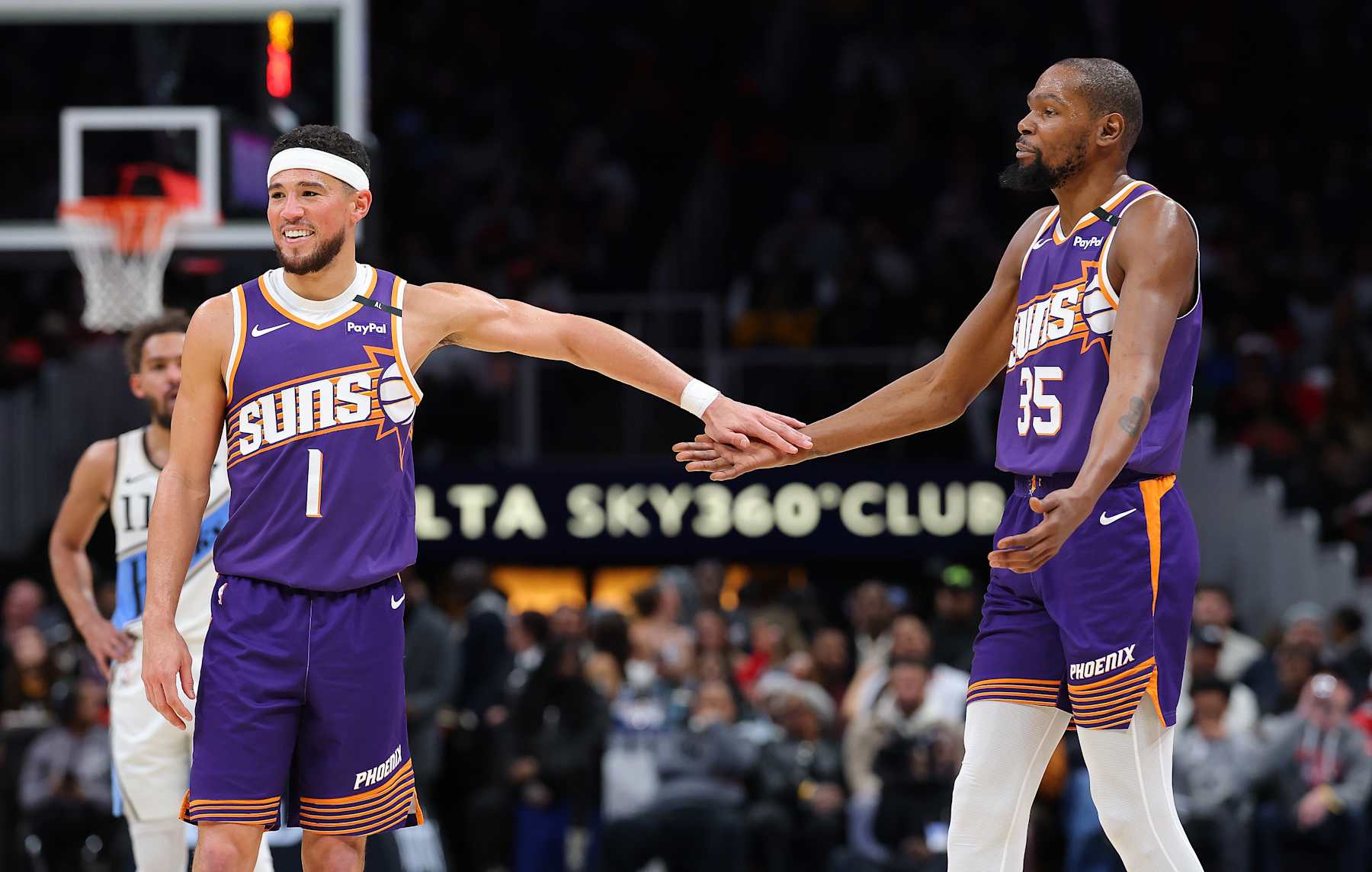 ATLANTA, GEORGIA - JANUARY 14:  Devin Booker #1 and Kevin Durant #35 of the Phoenix Suns reacts against the Atlanta Hawks during the third quarter at State Farm Arena on January 14, 2025 in Atlanta, Georgia.  NOTE TO USER: User expressly acknowledges and agrees that, by downloading and/or using this photograph, user is consenting to the terms and conditions of the Getty Images License Agreement.  (Photo by Kevin C. Cox/Getty Images)