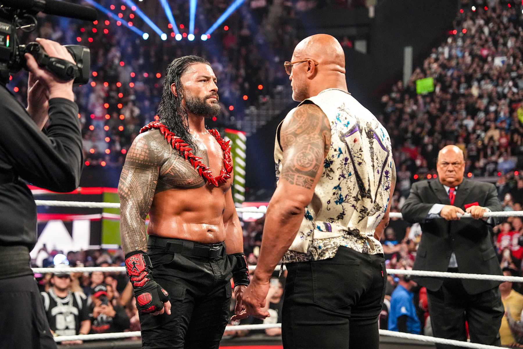 INGLEWOOD, CALIFORNIA - JANUARY 6: Roman Reigns and Dwayne "The Rock" Johnson face-off during RAW at Intuit Dome on January 6, 2025 in Inglewood, California.  (Photo by WWE/Getty Images)