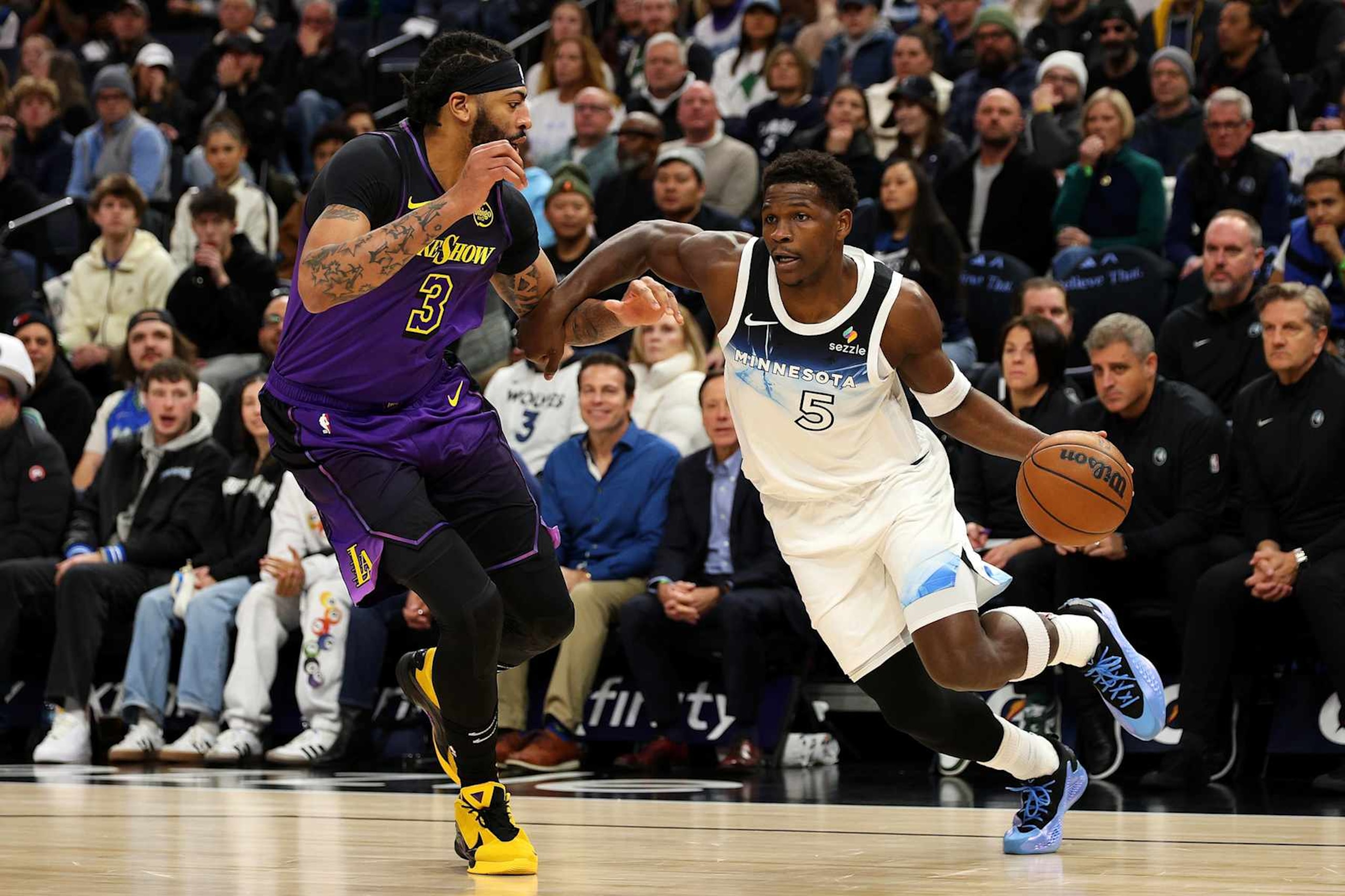 MINNEAPOLIS, MINNESOTA - DECEMBER 02: Anthony Edwards #5 of the Minnesota Timberwolves drives to the basket against Anthony Davis #3 of the Los Angeles Lakers in the first quarter at Target Center on December 02, 2024 in Minneapolis, Minnesota. The Timberwolves defeated the Lakers 109-80. NOTE TO USER: User expressly acknowledges and agrees that, by downloading and or using this photograph, User is consenting to the terms and conditions of the Getty Images License Agreement. (Photo by David Berding/Getty Images)