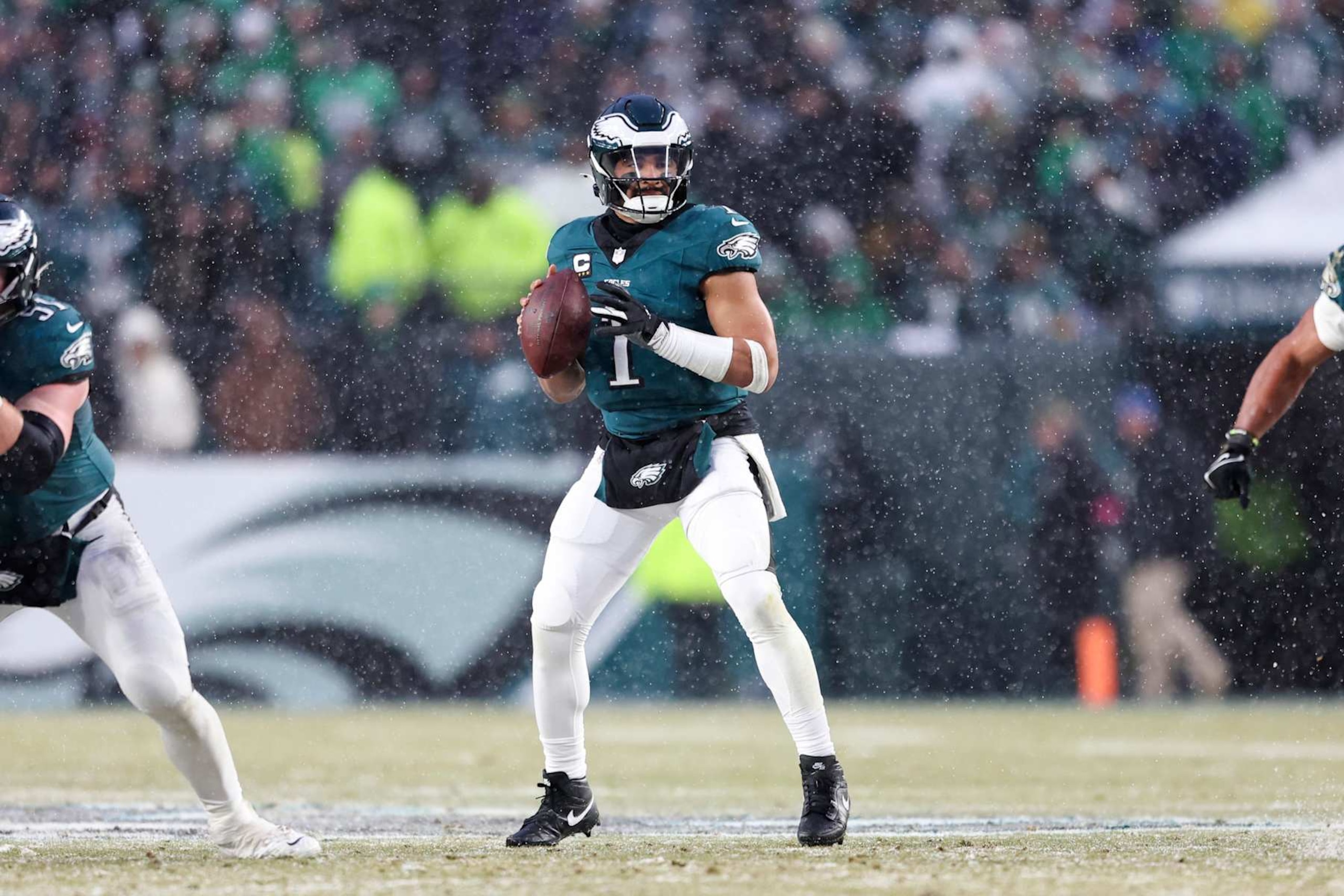 PHILADELPHIA, PENNSYLVANIA - JANUARY 19: Jalen Hurts #1 of the Philadelphia Eagles drops back to pass during the NFC Divisional playoff game against the Los Angeles Rams at Lincoln Financial Field on January 19, 2025 in Philadelphia, Pennsylvania. The Eagles defeated the Rams 28-22. (Kara Durrette/Getty Images)