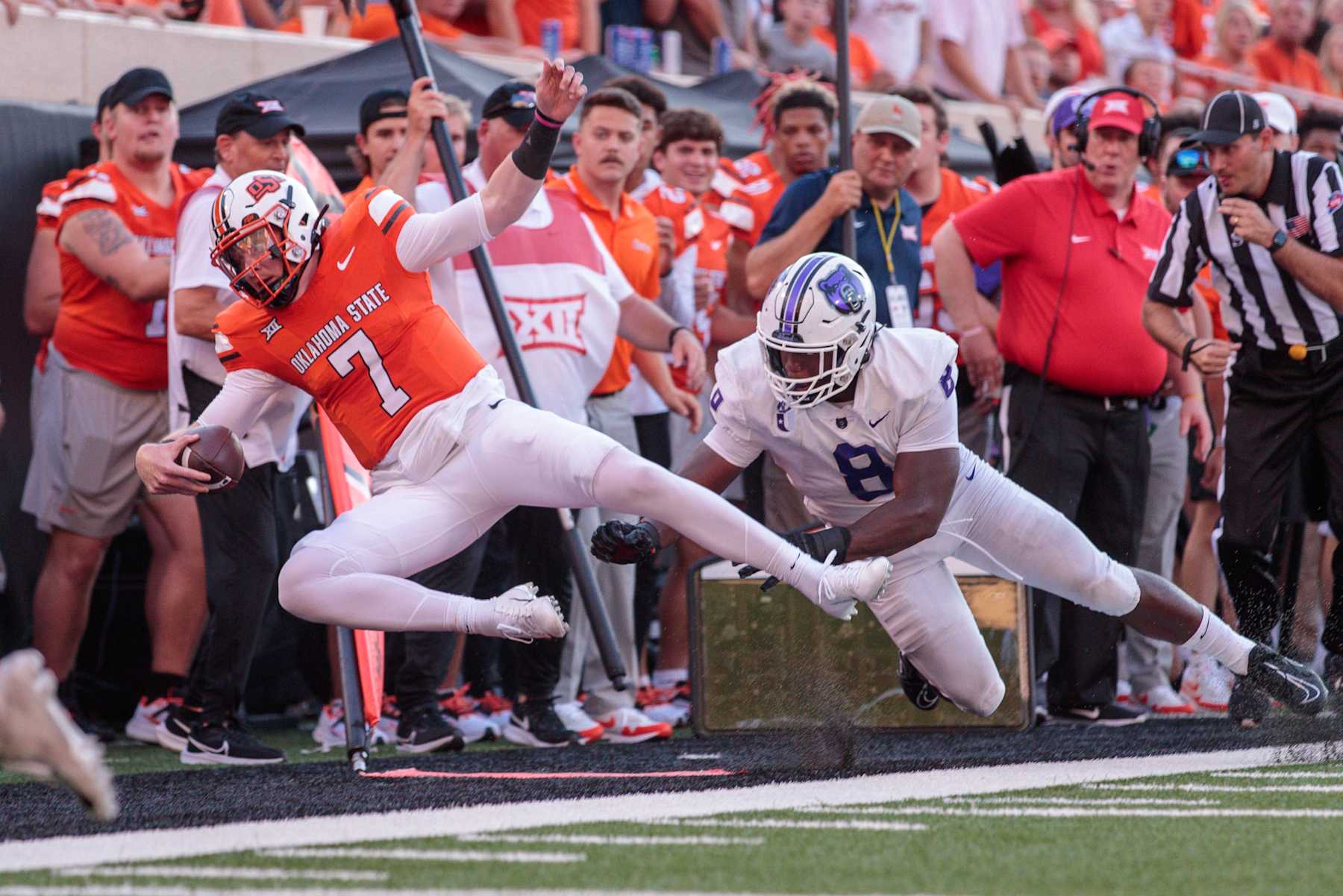 STILLWATER, OK - SEPTEMBER 02: Central Arkansas Bears defensive end David Walker (8) hits Oklahoma State Cowboys quarterback Alan Bowman (7) along the sidelines at Boone Pickens Stadium on September, 02 2023 in Stillwater, Oklahoma. (Photo by William Purnell/Icon Sportswire via Getty Images)