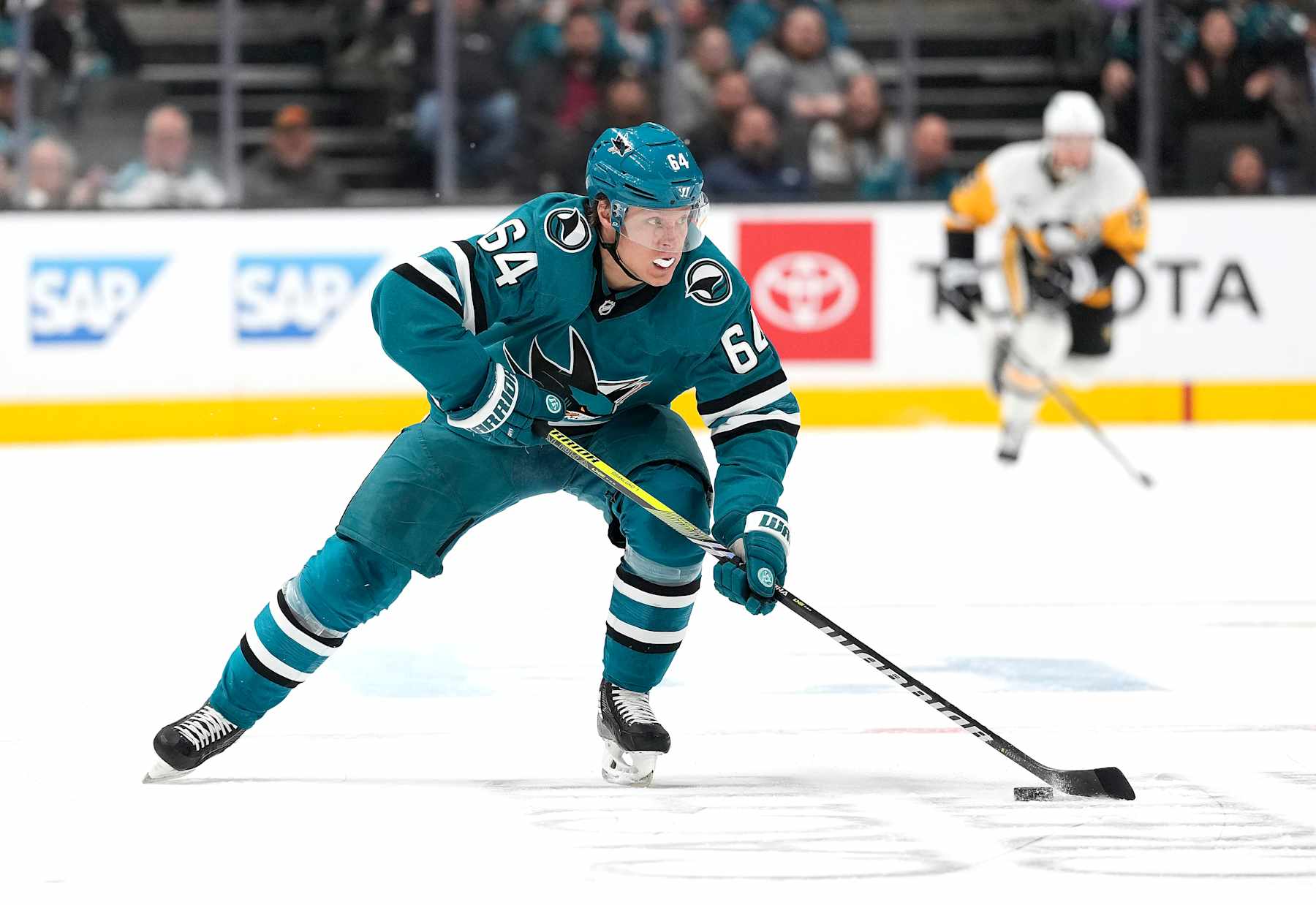 SAN JOSE, CALIFORNIA - JANUARY 27: Mikael Granlund #64 of the San Jose Sharks skates with the puck against the Pittsburgh Penguins during the second period of an NHL hockey game at SAP Center on January 27, 2025 in San Jose, California. (Photo by Thearon W. Henderson/Getty Images)