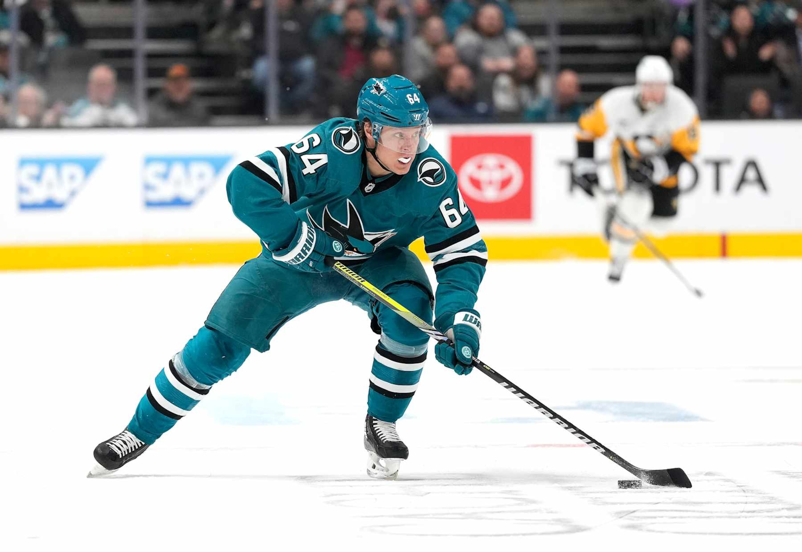 SAN JOSE, CALIFORNIA - JANUARY 27: Mikael Granlund #64 of the San Jose Sharks skates with the puck against the Pittsburgh Penguins during the second period of an NHL hockey game at SAP Center on January 27, 2025 in San Jose, California. (Photo by Thearon W. Henderson/Getty Images)