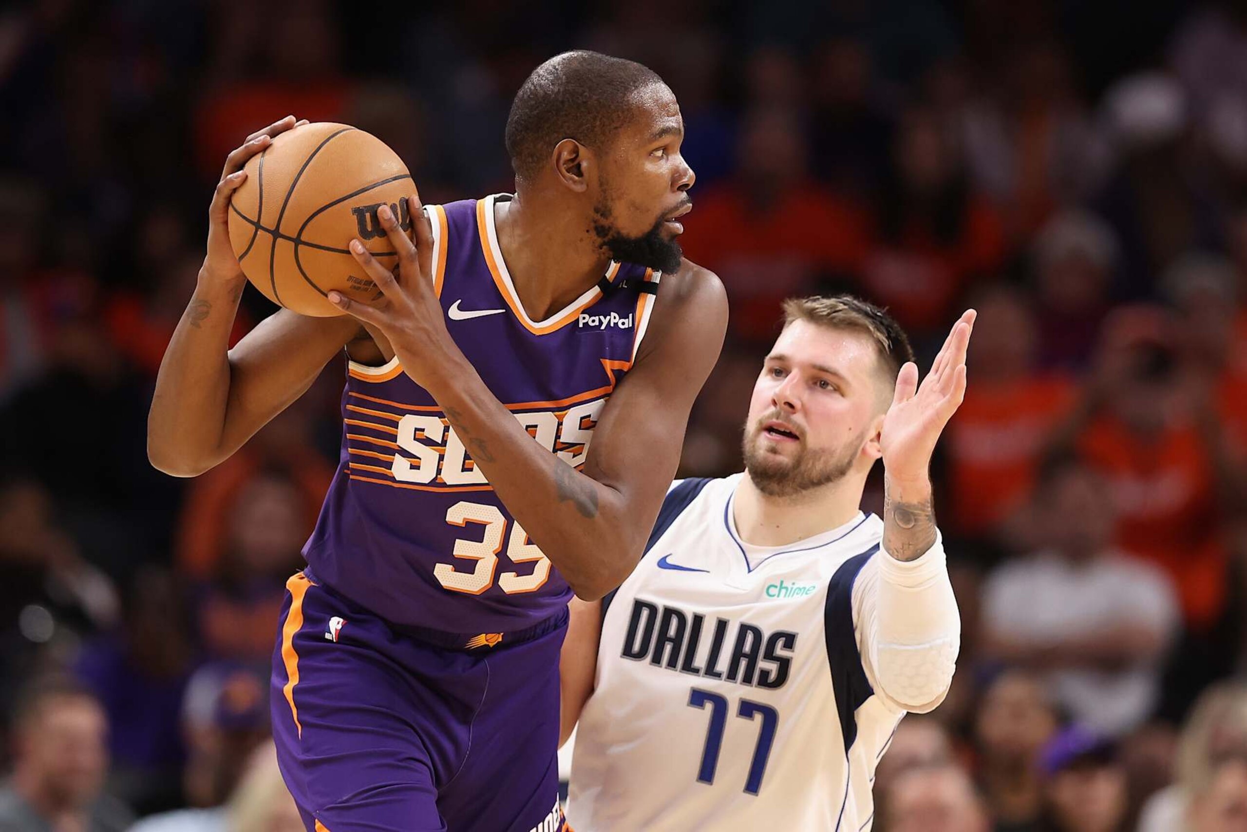 PHOENIX, ARIZONA - OCTOBER 26: Kevin Durant #35 of the Phoenix Suns handles the ball against Luka Doncic #77 of the Dallas Mavericks during the NBA game at Footprint Center on October 26, 2024 in Phoenix, Arizona. The Suns defeated the Mavericks 114-102.  NOTE TO USER: User expressly acknowledges and agrees that, by downloading and/or using this photograph, user is consenting to the terms and conditions of the Getty Images License Agreement. (Photo by Christian Petersen/Getty Images)