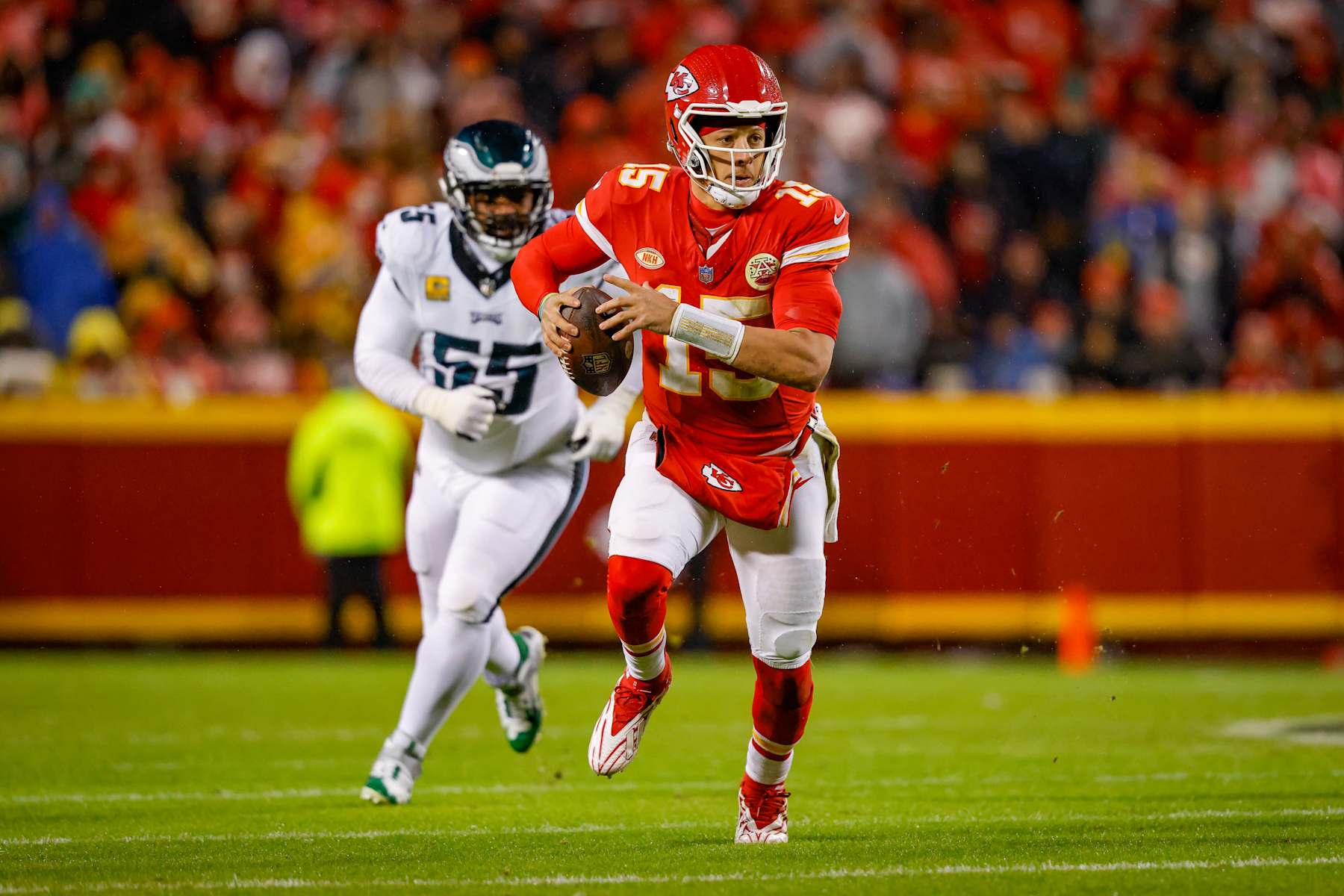 KANSAS CITY, MISSOURI - NOVEMBER 20: Patrick Mahomes #15 of the Kansas City Chiefs scrambles away from Brandon Graham #55 of the Philadelphia Eagles during the second quarter at GEHA Field at Arrowhead Stadium on November 20, 2023 in Kansas City, Missouri. (Photo by David Eulitt/Getty Images)