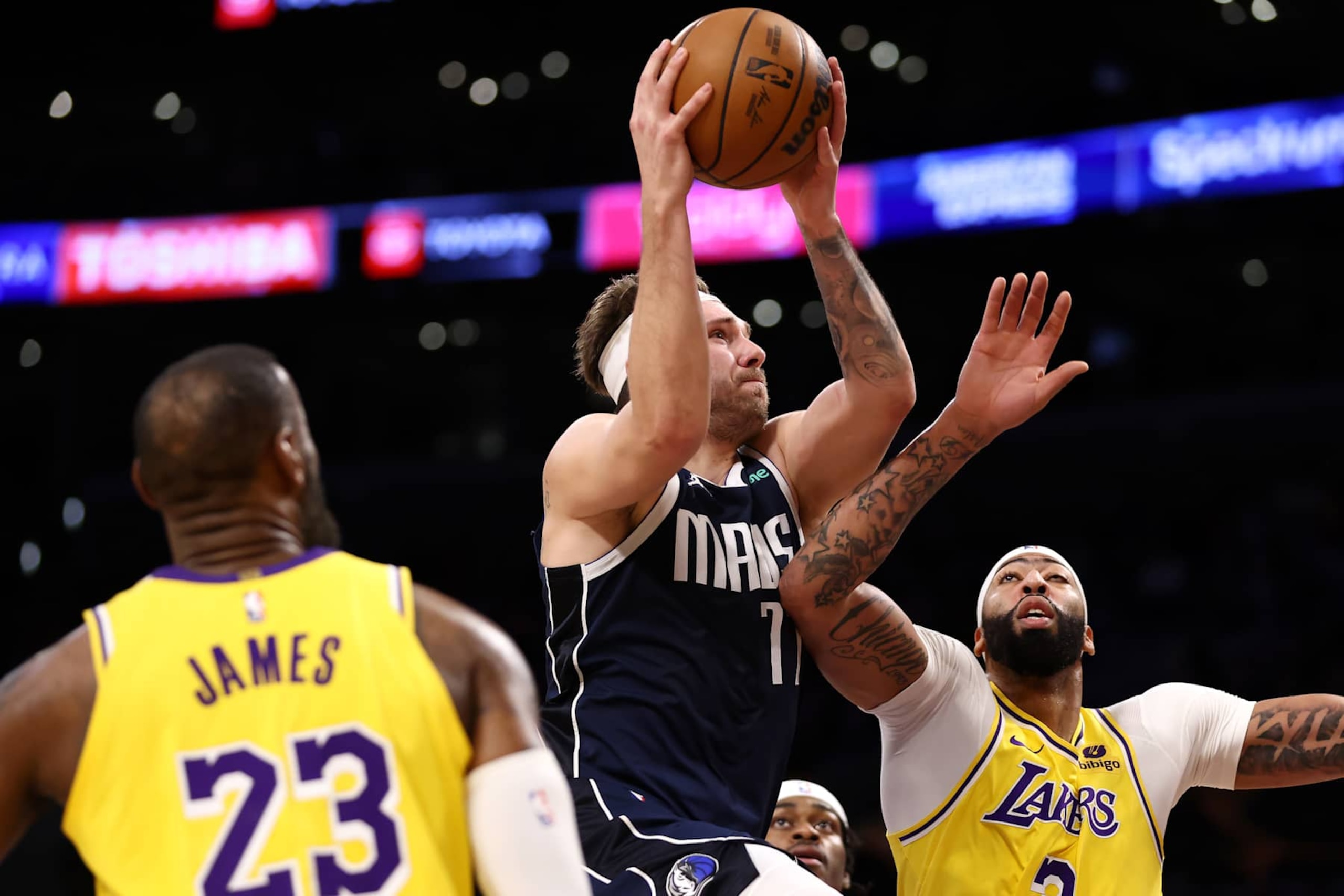 LOS ANGELES, CALIFORNIA - JANUARY 17: Luka Doncic #77 of the Dallas Mavericks drives to the basket against LeBron James #23 and Anthony Davis #3 of the Los Angeles Lakers during the first quarter at Crypto.com Arena on January 17, 2024 in Los Angeles, California. NOTE TO USER: User expressly acknowledges and agrees that, by downloading and or using this photograph, User is consenting to the terms and conditions of the Getty Images License Agreement. (Photo by Katelyn Mulcahy/Getty Images)