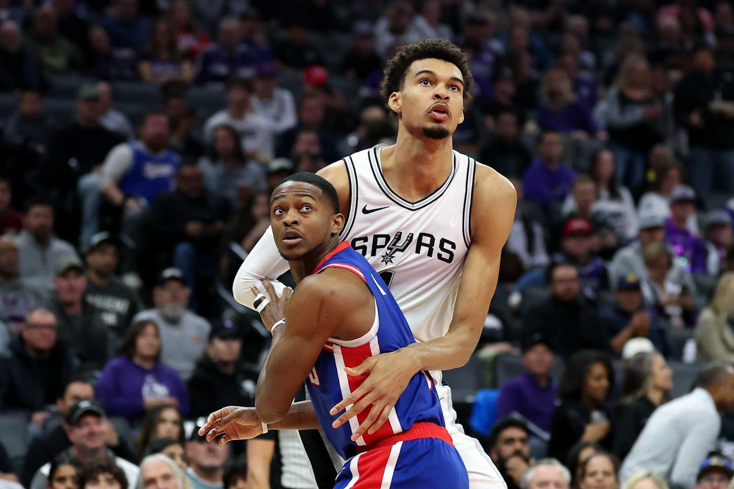 SACRAMENTO, CALIFORNIA - DECEMBER 01: Victor Wembanyama #1 of the San Antonio Spurs and De'Aaron Fox #5 of the Sacramento Kings go for a rebound in the first half at Golden 1 Center on December 01, 2024 in Sacramento, California. NOTE TO USER: User expressly acknowledges and agrees that, by downloading and/or using this photograph, user is consenting to the terms and conditions of the Getty Images License Agreement.   (Photo by Ezra Shaw/Getty Images)