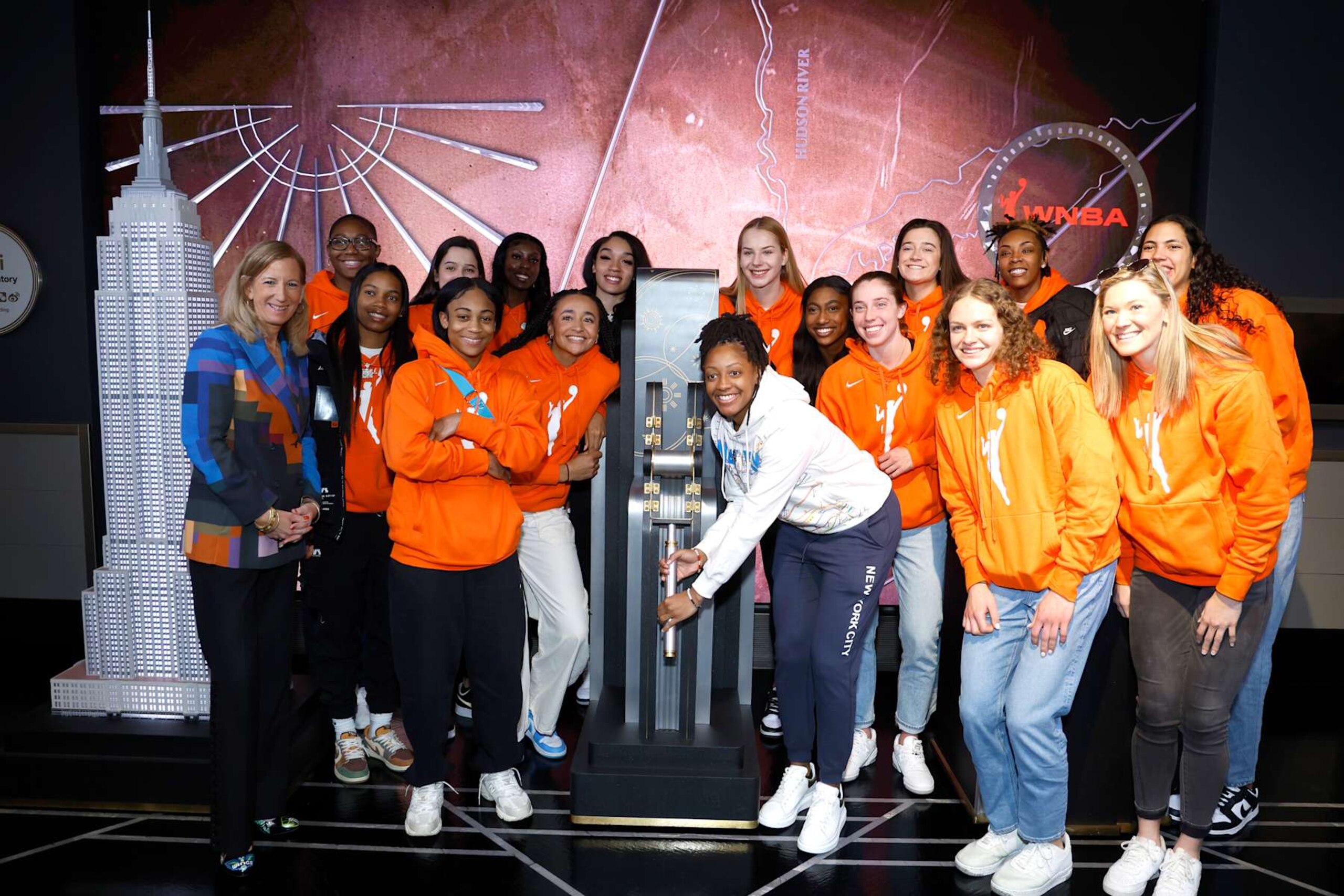 NEW YORK, NEW YORK - APRIL 10: WNBA Commissioner Cathy Engelbert (L), Kelsey Mitchell (center R) & WNBA Draftees Alexis Morris, Aliyah Boston, Zia Cooke, Lou Lopez Senechal, Haley Jones, Laeticia Amihere, Brea Beal, Dorka Juhasz, Diamond Miller, Taylor Mikesell, Grace Berger, Jordan Horston, Ashley Joens, and Stephanie Soares light the Empire State Building in celebration of the 2023 WNBA Draft at The Empire State Building on April 10, 2023 in New York City. (Photo by John Lamparski/Getty Images for Empire State Realty Trust)