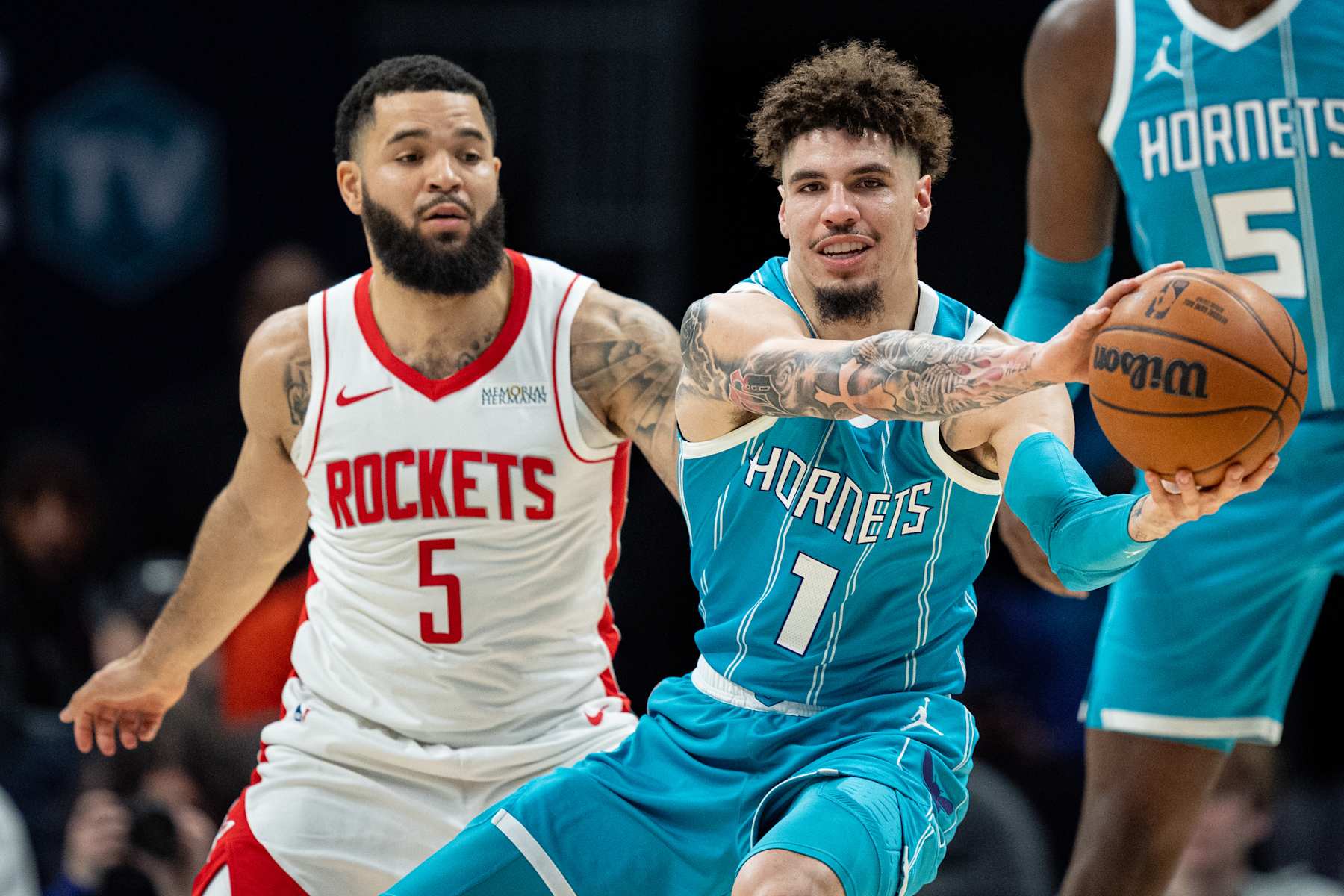 CHARLOTTE, NORTH CAROLINA - DECEMBER 23: Fred VanVleet #5 of the Houston Rockets guards LaMelo Ball #1 of the Charlotte Hornets in the first quarter during their game at Spectrum Center on December 23, 2024 in Charlotte, North Carolina. NOTE TO USER: User expressly acknowledges and agrees that, by downloading and or using this photograph, User is consenting to the terms and conditions of the Getty Images License Agreement. (Photo by Jacob Kupferman/Getty Images)