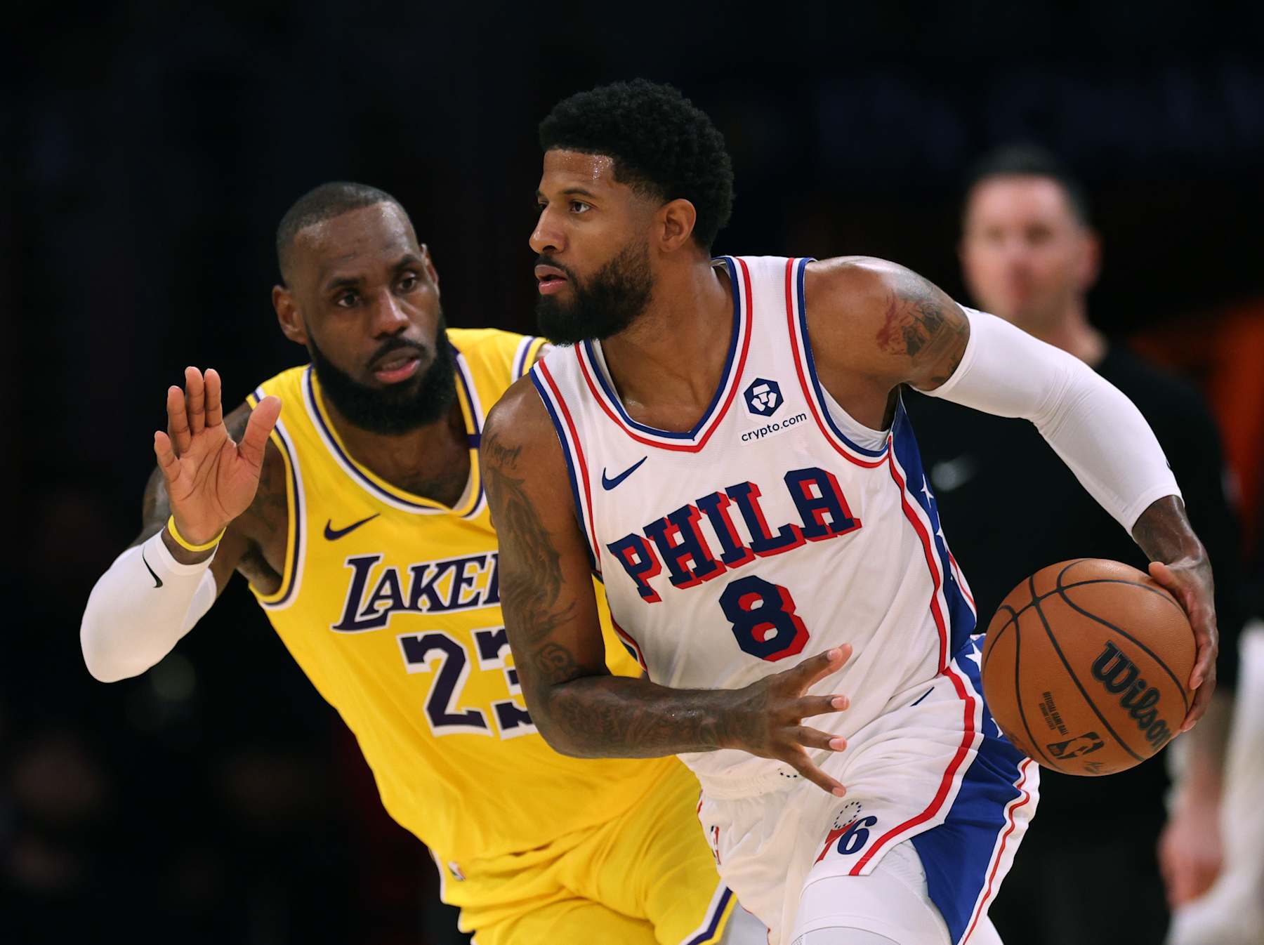 LOS ANGELES, CALIFORNIA - NOVEMBER 08: Paul George #8 of the Philadelphia 76ers dribbles as he is guarded by LeBron James #23 of the Los Angeles Lakers during a 116-106 Lakers win at Crypto.com Arena on November 08, 2024 in Los Angeles, California. (Photo by Harry How/Getty Images) NOTE TO USER: User expressly acknowledges and agrees that, by downloading and/or using this Photograph, user is consenting to the terms and conditions of the Getty Images License Agreement. (Photo by Harry How/Getty Images)
