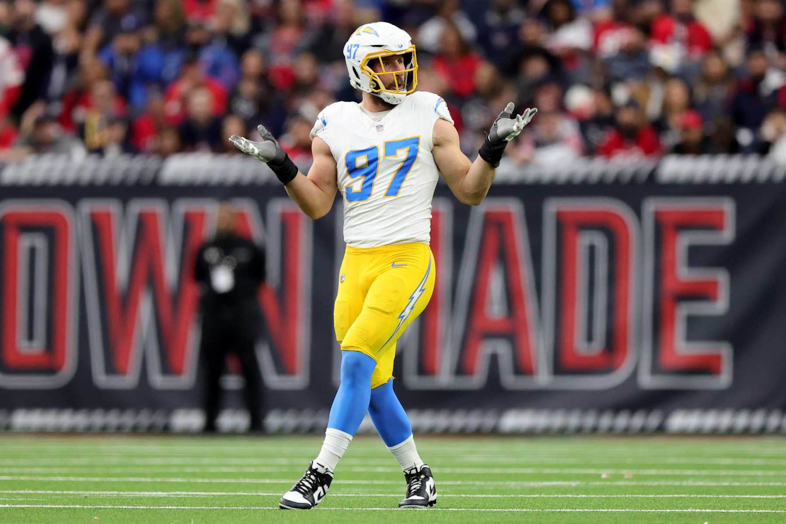 HOUSTON, TEXAS - JANUARY 11: Joey Bosa #97 of the Los Angeles Chargers reacts after a sack against the Houston Texans in the first quarter during the AFC Wild Card Playoffs at NRG Stadium on January 11, 2025 in Houston, Texas. (Photo by Alex Slitz/Getty Images)