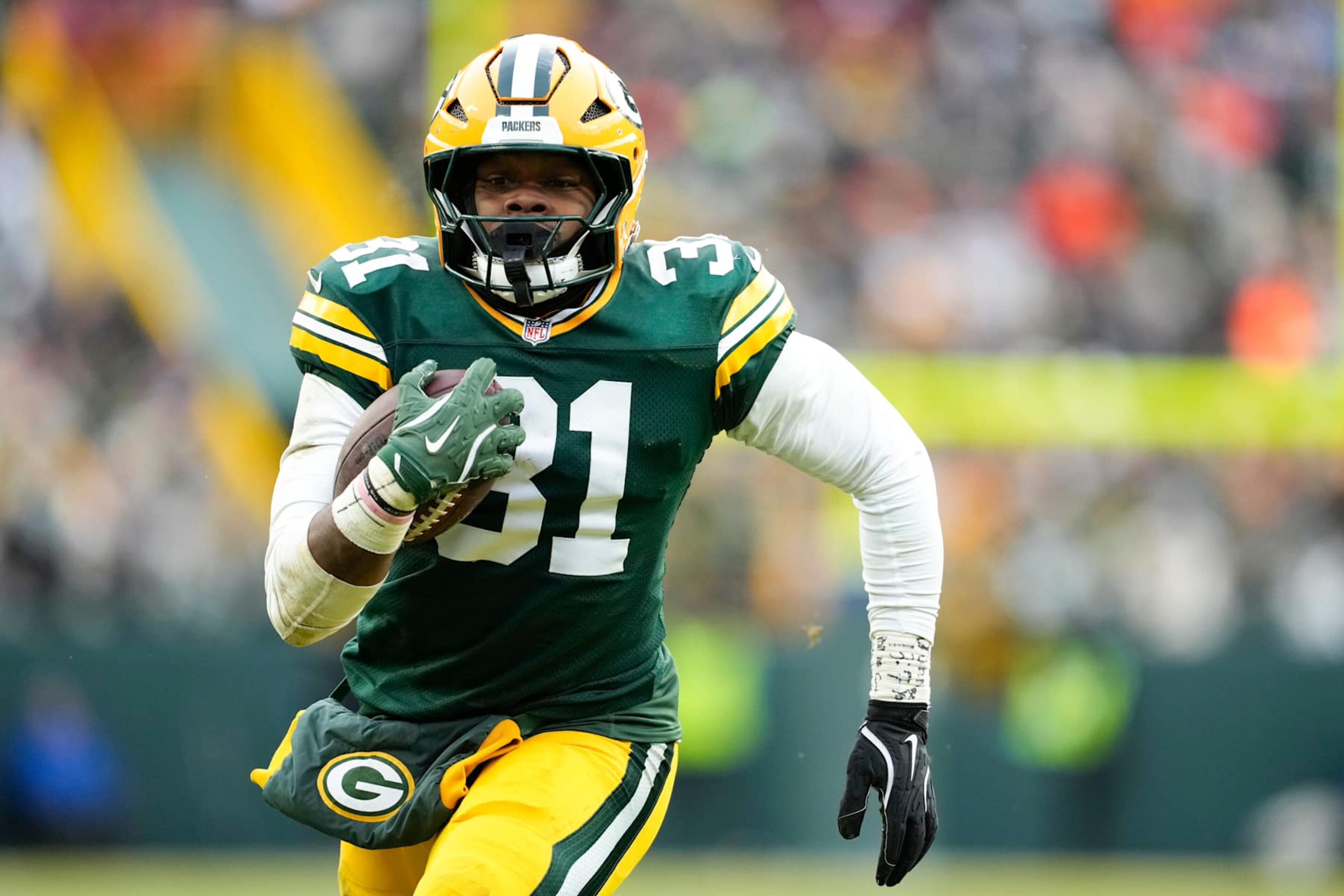 GREEN BAY, WISCONSIN - JANUARY 05: Emanuel Wilson #31 of the Green Bay Packers runs with the ball in the fourth quarter against the Chicago Bears at Lambeau Field on January 05, 2025 in Green Bay, Wisconsin. (Photo by Patrick McDermott/Getty Images) GREEN BAY, WISCONSIN - JANUARY 05: Emanuel Wilson #31 of the Green Bay Packers runs with the ball in the fourth quarter against the Chicago Bears at Lambeau Field on January 05, 2025 in Green Bay, Wisconsin. (Photo by Patrick McDermott/Getty Images)