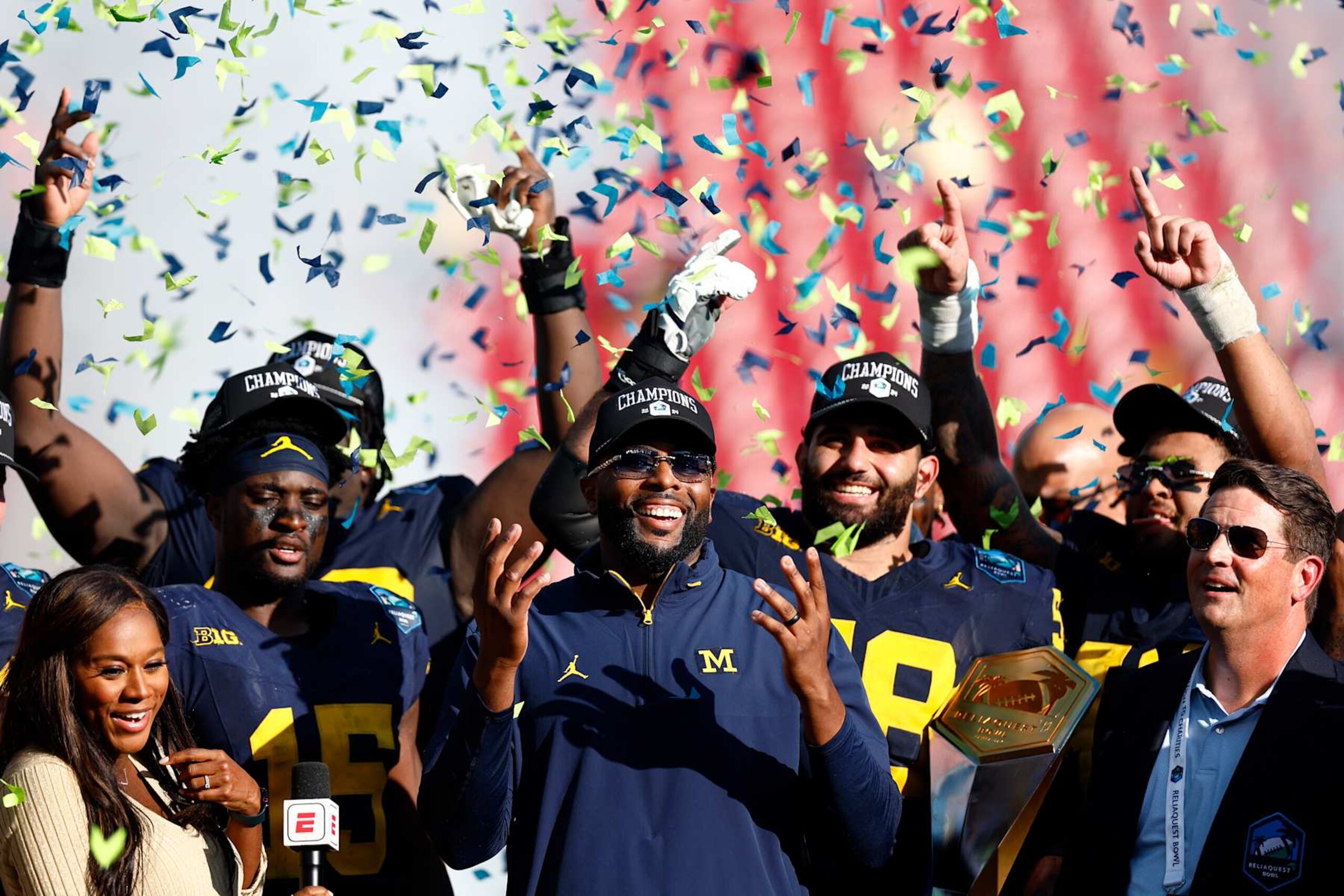 TAMPA, FLORIDA - DECEMBER 31: Head coach Sherrone Moore of the Michigan Wolverines celebrates with players after defeating the Michigan Wolverines 19-13 during the 2024 ReliaQuest Bowl at Raymond James Stadium on December 31, 2024 in Tampa, Florida.  (Photo by Douglas P. DeFelice/Getty Images)