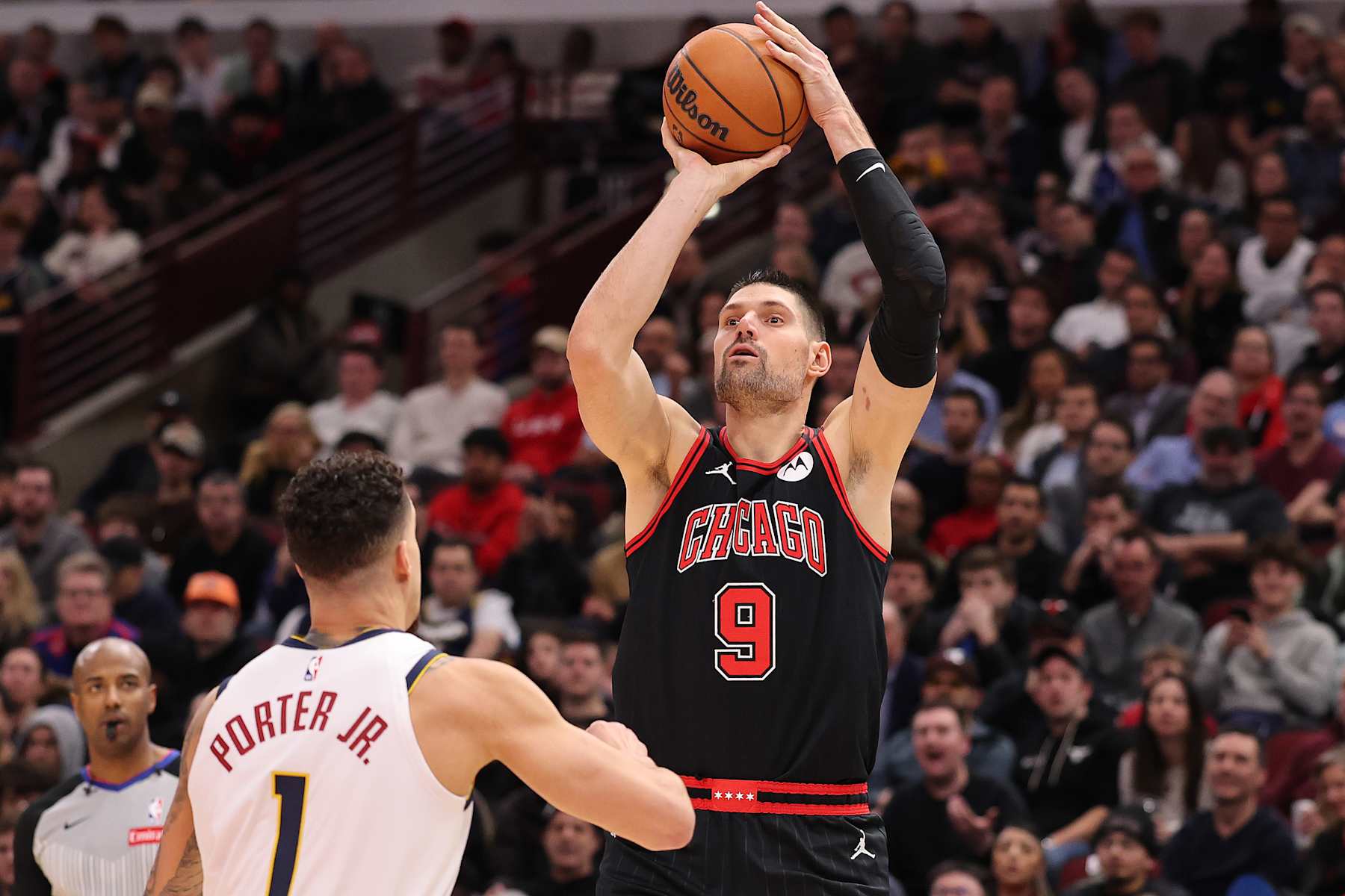 CHICAGO, ILLINOIS - JANUARY 27: Nikola Vucevic #9 of the Chicago Bulls shoots over Michael Porter Jr. #1 of the Denver Nuggets during the second half at the United Center on January 27, 2025 in Chicago, Illinois. NOTE TO USER: User expressly acknowledges and agrees that, by downloading and or using this photograph, User is consenting to the terms and conditions of the Getty Images License Agreement.  (Photo by Michael Reaves/Getty Images)