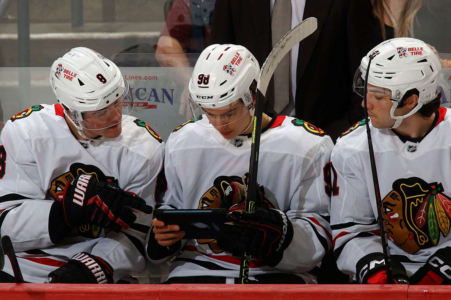SUNRISE, FLORIDA -FEBRUARY 1: Connor Bedard #98 of the Chicago Blackhawks reviews plays with teammates Ryan Donato #8 and Frank Nazar #91 during a break in the action against the Florida Panthers at the Amerant Bank Arena on February 1, 2025 in Sunrise, Florida. (Photo by Eliot J. Schechter/NHLI via Getty Images)