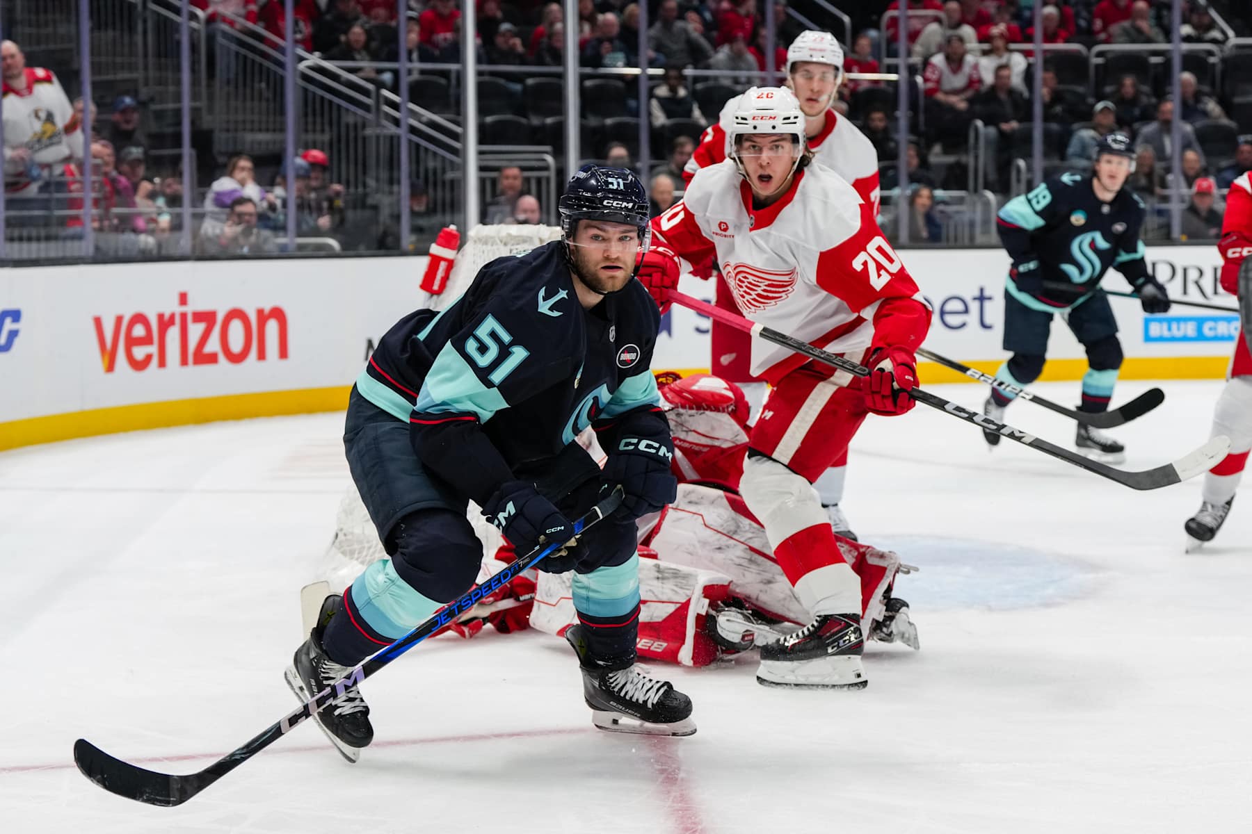 SEATTLE, WASHINGTON - FEBRUARY 04: Shane Wright #51 of the Seattle Kraken and Albert Johansson #20 of the Detroit Red Wings react during the second period of a game at Climate Pledge Arena on February 04, 2025 in Seattle, Washington. (Photo by Liv Lyons/NHLI via Getty Images)
