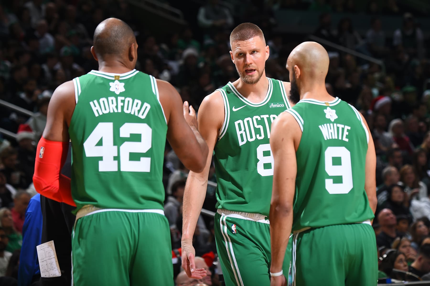 BOSTON, MA - DECEMBER 25: Kristaps Porzingis #8 of the Boston Celtics talks to Al Horford #42 during the game against the Philadelphia 76ers on December 25, 2024 at the TD Garden in Boston, Massachusetts. NOTE TO USER: User expressly acknowledges and agrees that, by downloading and or using this photograph, User is consenting to the terms and conditions of the Getty Images License Agreement. Mandatory Copyright Notice: Copyright 2024 NBAE(Photo by Brian Babineau/NBAE via Getty Images)