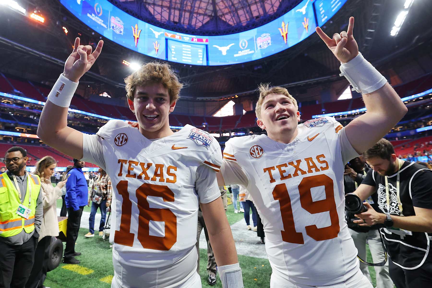 ATLANTA, GEORGIA - JANUARY 01: Arch Manning #16 and Cole Lourd #19 of the Texas Longhorns celebrate after defeating the Arizona State Sun Devils 39-31 during the second overtime in the Chick-fil-A Peach Bowl at Mercedes-Benz Stadium on January 01, 2025 in Atlanta, Georgia.  (Photo by Kevin C. Cox/Getty Images)