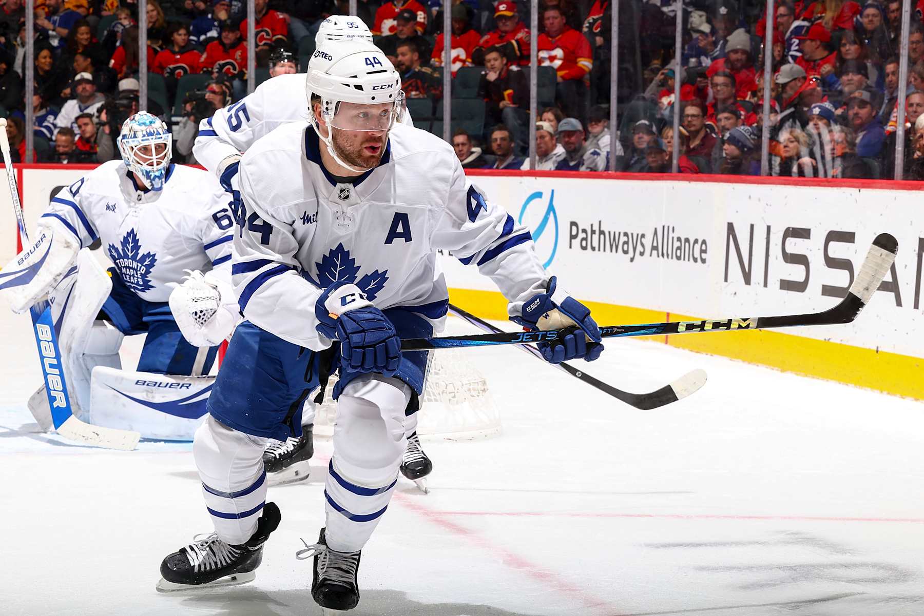 CALGARY, AB - FEBRUARY 4: Morgan Rielly #44 of the Toronto Maple Leafs tracks down the loose puck against the Calgary Flames at Scotiabank Saddledome on February 4, 2025 in Calgary, Alberta, Canada. (Photo by Gerry Thomas/NHLI via Getty Images)