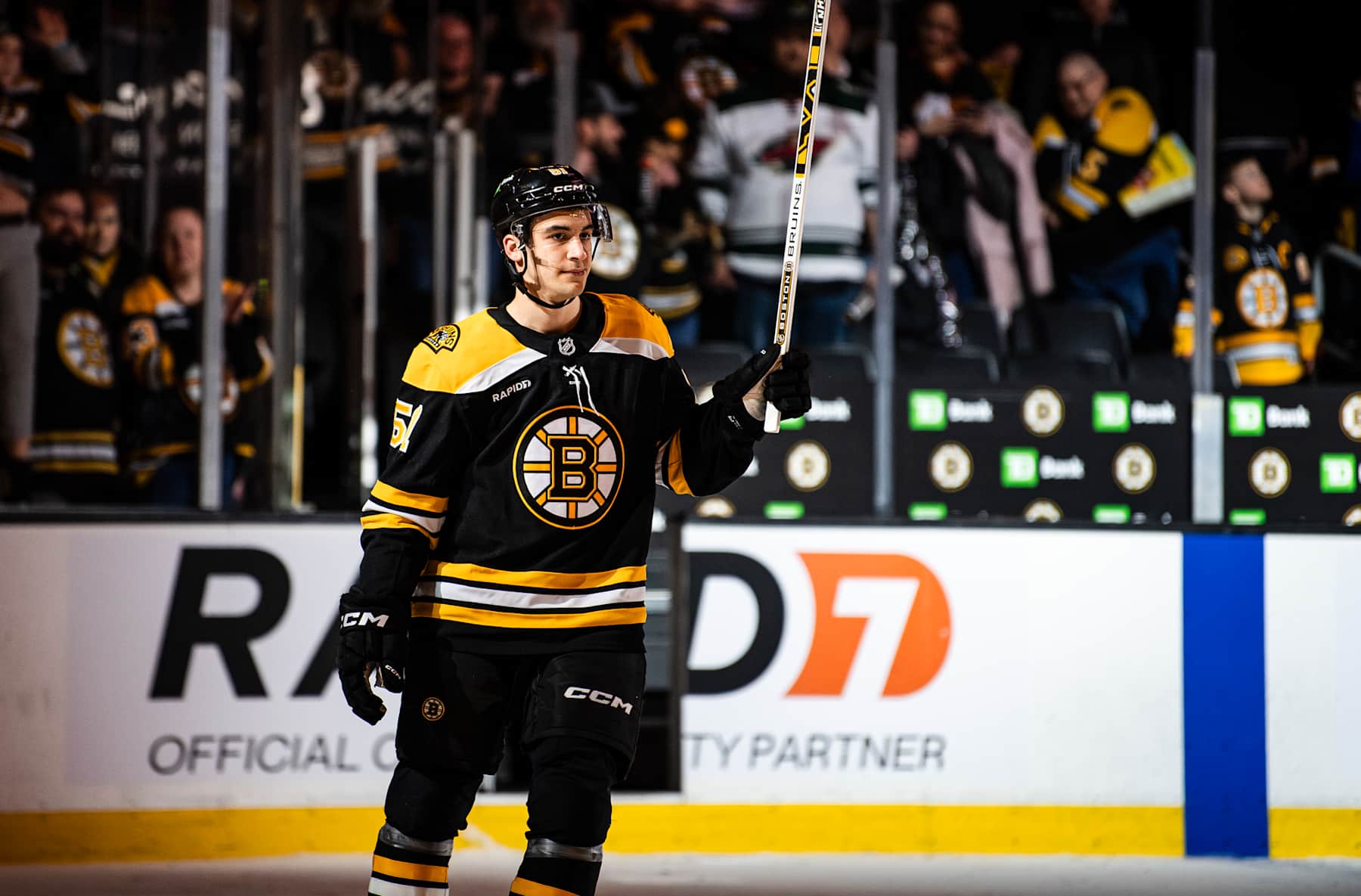 BOSTON, MASSACHUSETTS - FEBRUARY 04: Matthew Poitras #51 of the Boston Bruins skates during the three stars awards after the game against the Minnesota Wild at TD Garden on February 04, 2025 in Boston, Massachusetts. (Photo by China Wong/NHLI via Getty Images)
