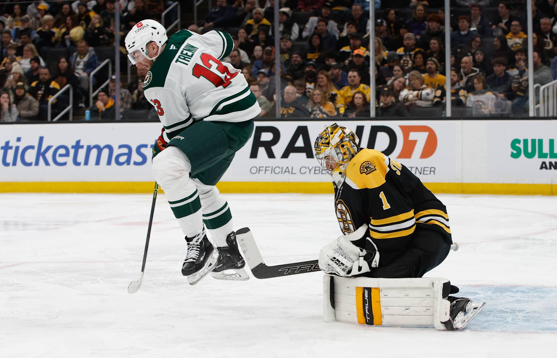 BOSTON, MASSACHUSETTS - FEBRUARY 4: Yakov Trenin #13 of the Minnesota Wild jumps to avoid the puck in front of Jeremy Swayman #1 of the Boston Bruins during the second period at the TD Garden on February 4, 2025 in Boston, Massachusetts. (Photo by Richard T Gagnon/Getty Images)