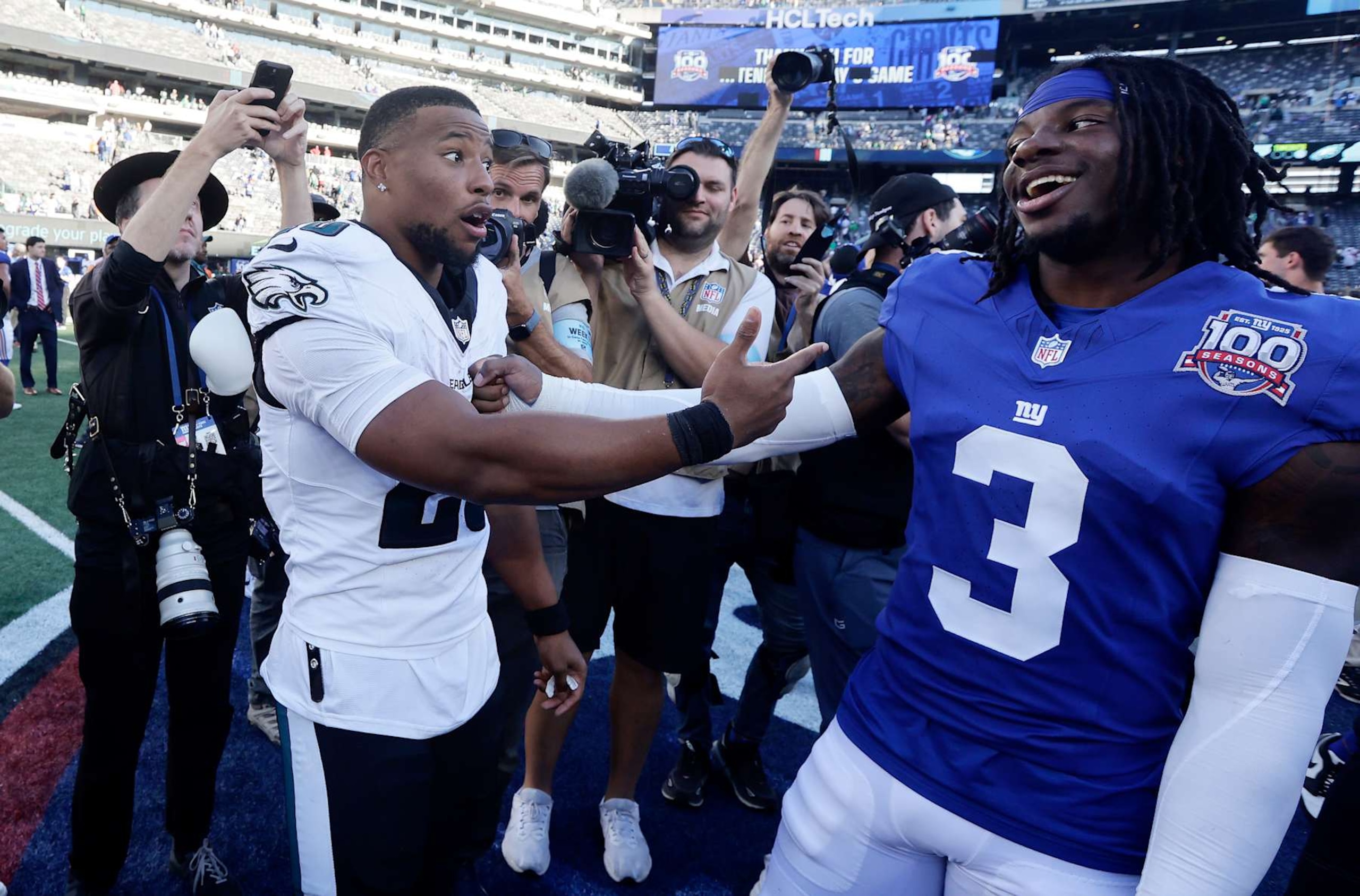 EAST RUTHERFORD, NEW JERSEY - OCTOBER 20: (NEW YORK DAILIES OUT)  Saquon Barkley #26 of the Philadelphia Eagles and Deonte Banks #3 of the New York Giants meet after their game at MetLife Stadium on October 20, 2024 in East Rutherford, New Jersey. The Eagles defeated the Giants 28-3. (Photo by Jim McIsaac/Getty Images)