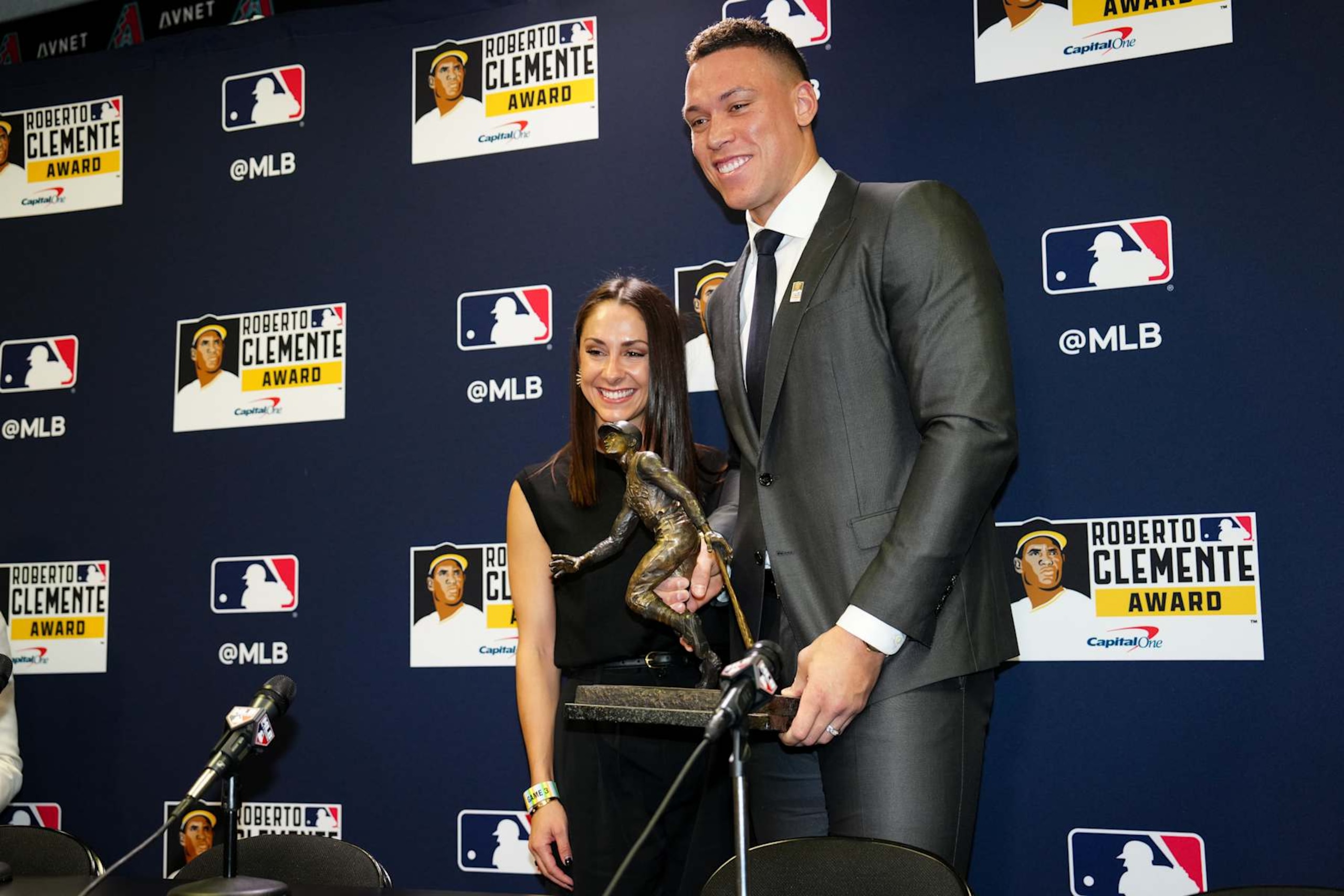 PHOENIX, AZ - OCTOBER 30: Roberto Clemente Award 2023 recipient Aaron Judge #99 of the New York Yankees poses for a photo with wife Samantha Bracksieck prior to Game 3 of the 2023 World Series between the Texas Rangers and the Arizona Diamondbacks at Chase Field on Monday, October 30, 2023 in Phoenix, Arizona. (Photo by Mary DeCicco/MLB Photos via Getty Images) PHOENIX, AZ - OCTOBER 30: Roberto Clemente Award 2023 recipient Aaron Judge #99 of the New York Yankees poses for a photo with wife Samantha Bracksieck prior to Game 3 of the 2023 World Series between the Texas Rangers and the Arizona Diamondbacks at Chase Field on Monday, October 30, 2023 in Phoenix, Arizona. (Photo by Mary DeCicco/MLB Photos via Getty Images)