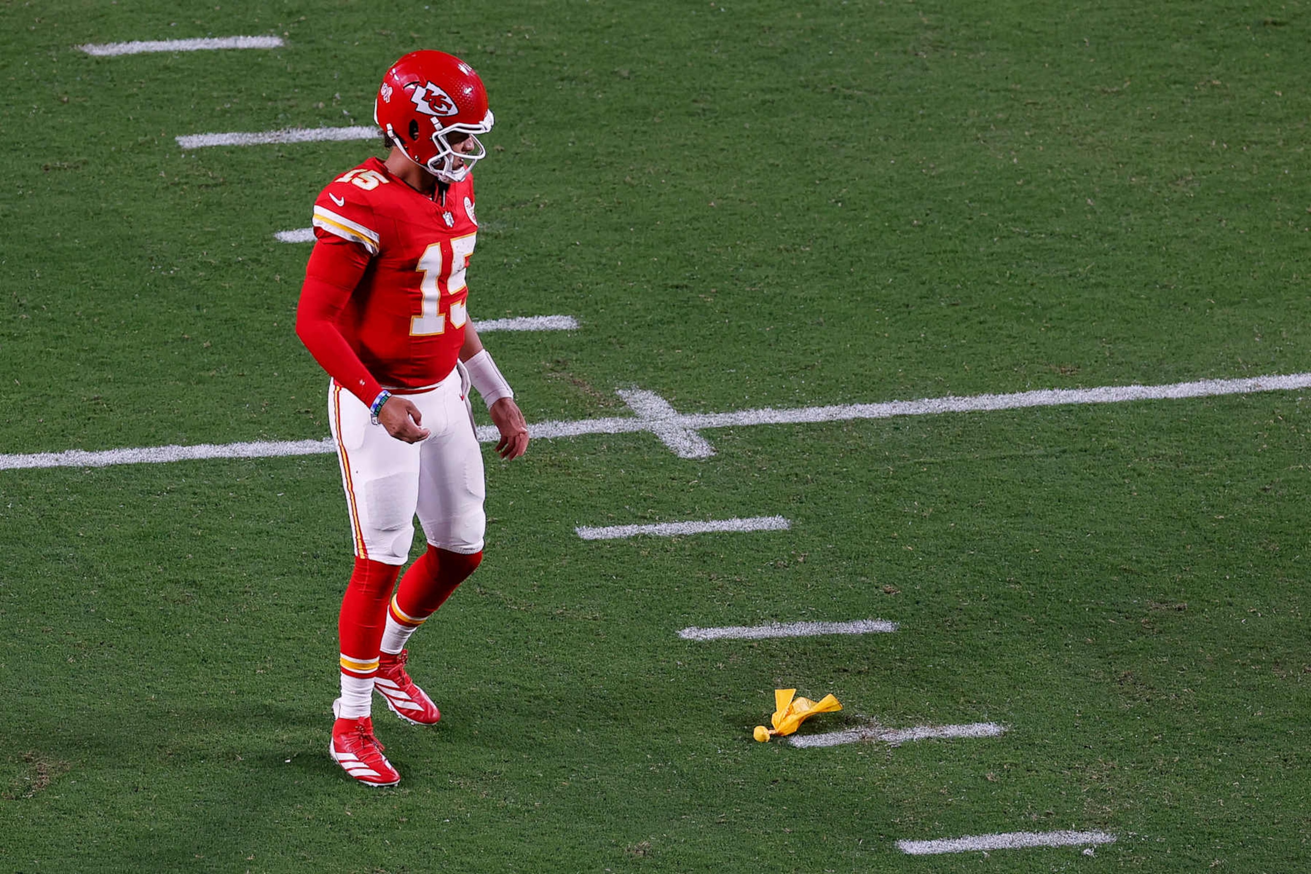 KANSAS CITY, MISSOURI - SEPTEMBER 5: Patrick Mahomes #15 of the Kansas City Chiefs stands next to a yellow penalty flag on the ground during the second half against the Baltimore Ravens at GEHA Field at Arrowhead Stadium on September 5, 2024 in Kansas City, Missouri. (Photo by Aaron M. Sprecher/Getty Images)
