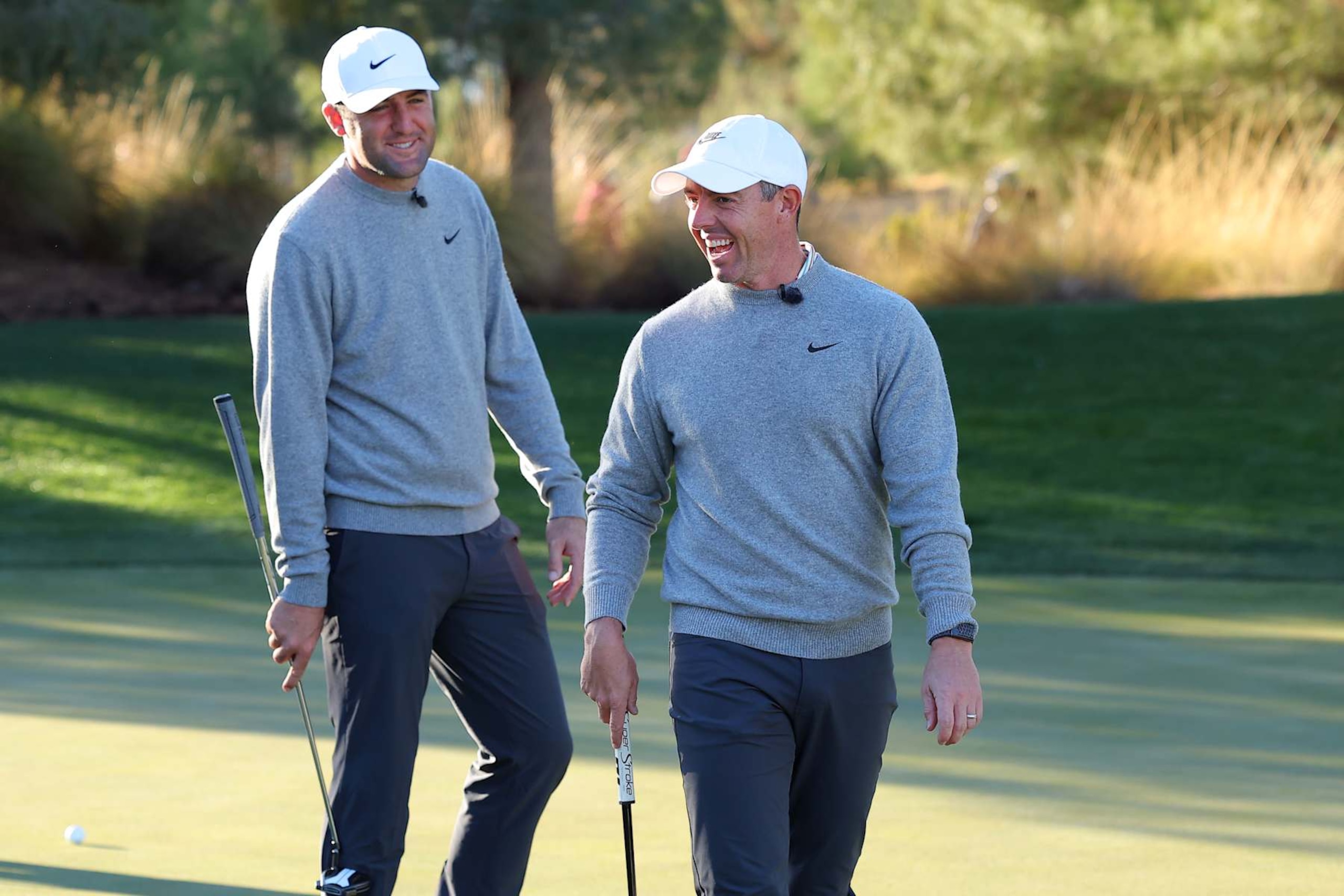 LAS VEGAS, NEVADA - DECEMBER 17: Scottie Scheffler (L) and Rory McIlroy of the PGA Tour talk during The Showdown: McIlroy and Scheffler v DeChambeau and Koepka at Shadow Creek Golf Course on December 17, 2024 in Las Vegas, Nevada.  (Photo by Kevin C. Cox/Getty Images for The Showdown)
