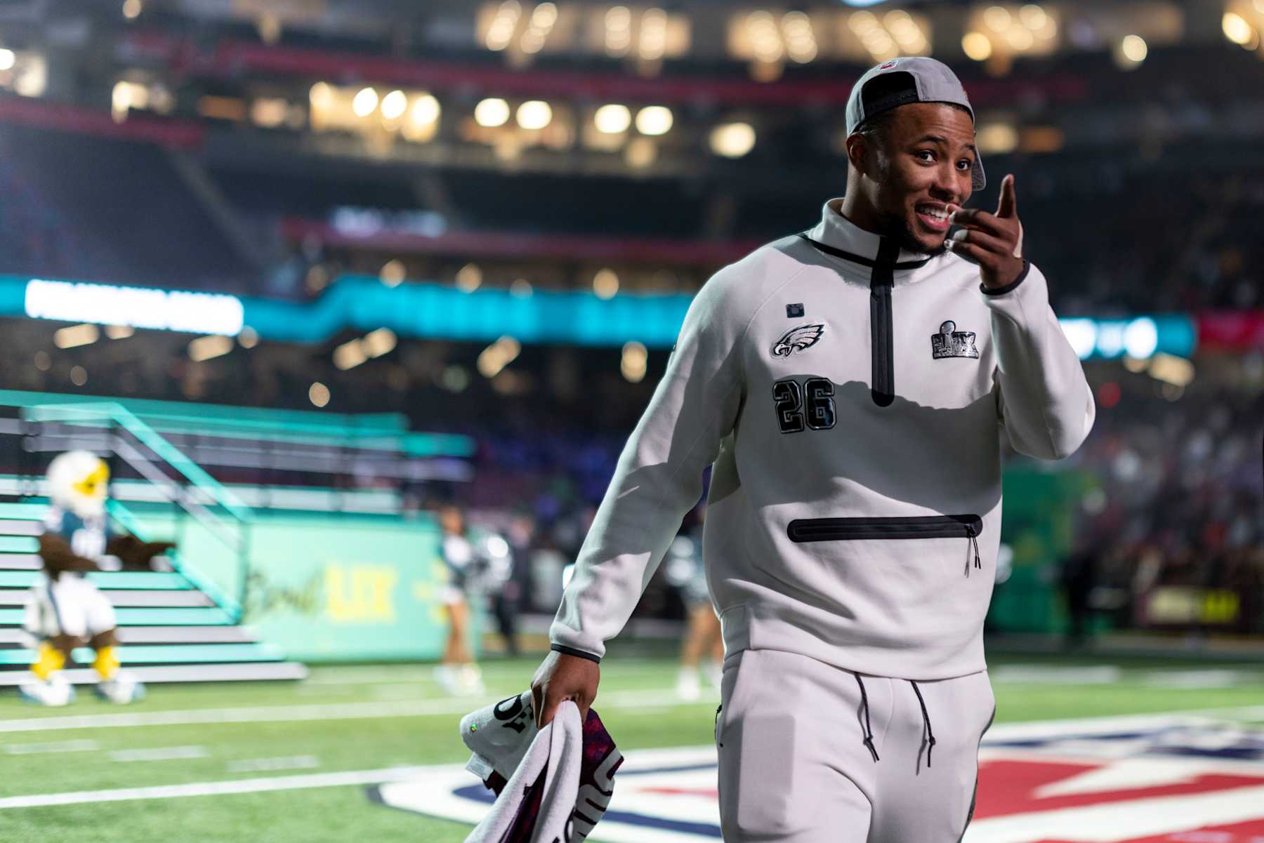 NEW ORLEANS, LOUISIANA - FEBRUARY 3: Saquon Barkley #26 of the Philadelphia Eagles reacts as he walks to his booth during Super Bowl LIX Opening Night on February 02, 2025 in New Orleans, Louisiana.  (Photo by Michael Owens/Getty Images)